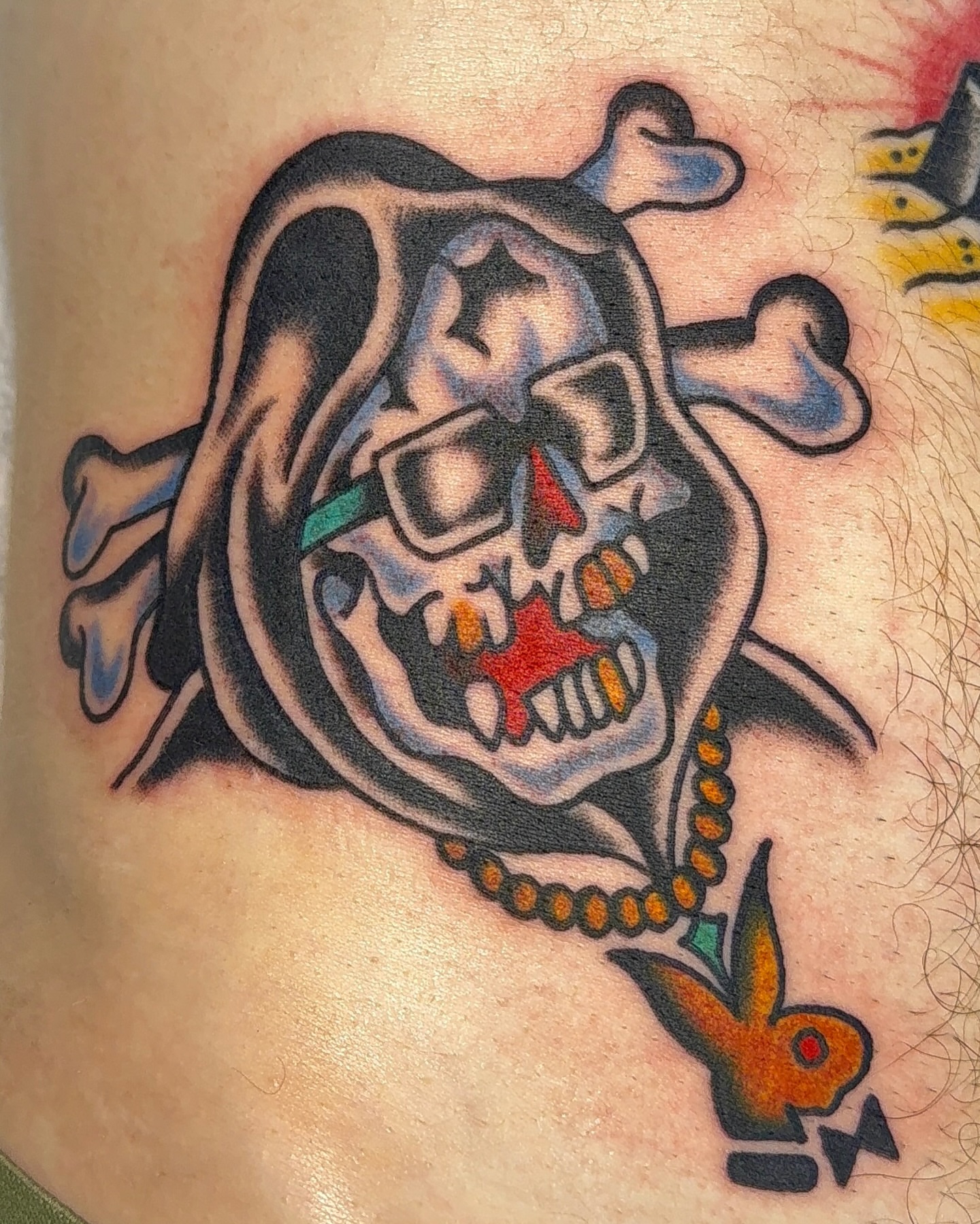 Skull with crossbones American traditional tattoo on the thigh by VAY