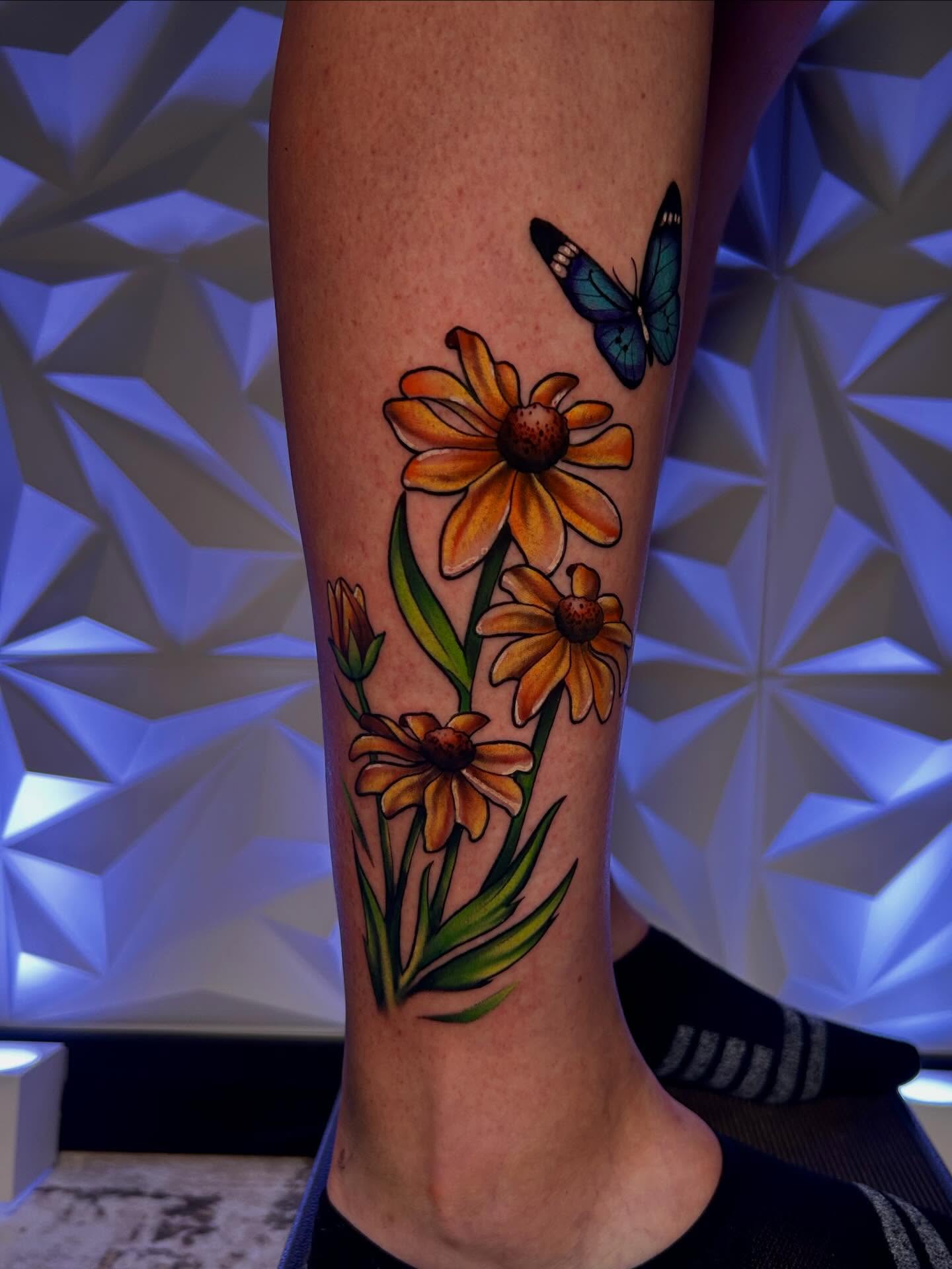 Flowers and butterfly realism tattoo on the calf by Haleigh Cunningham, Charlotte, North Carolina