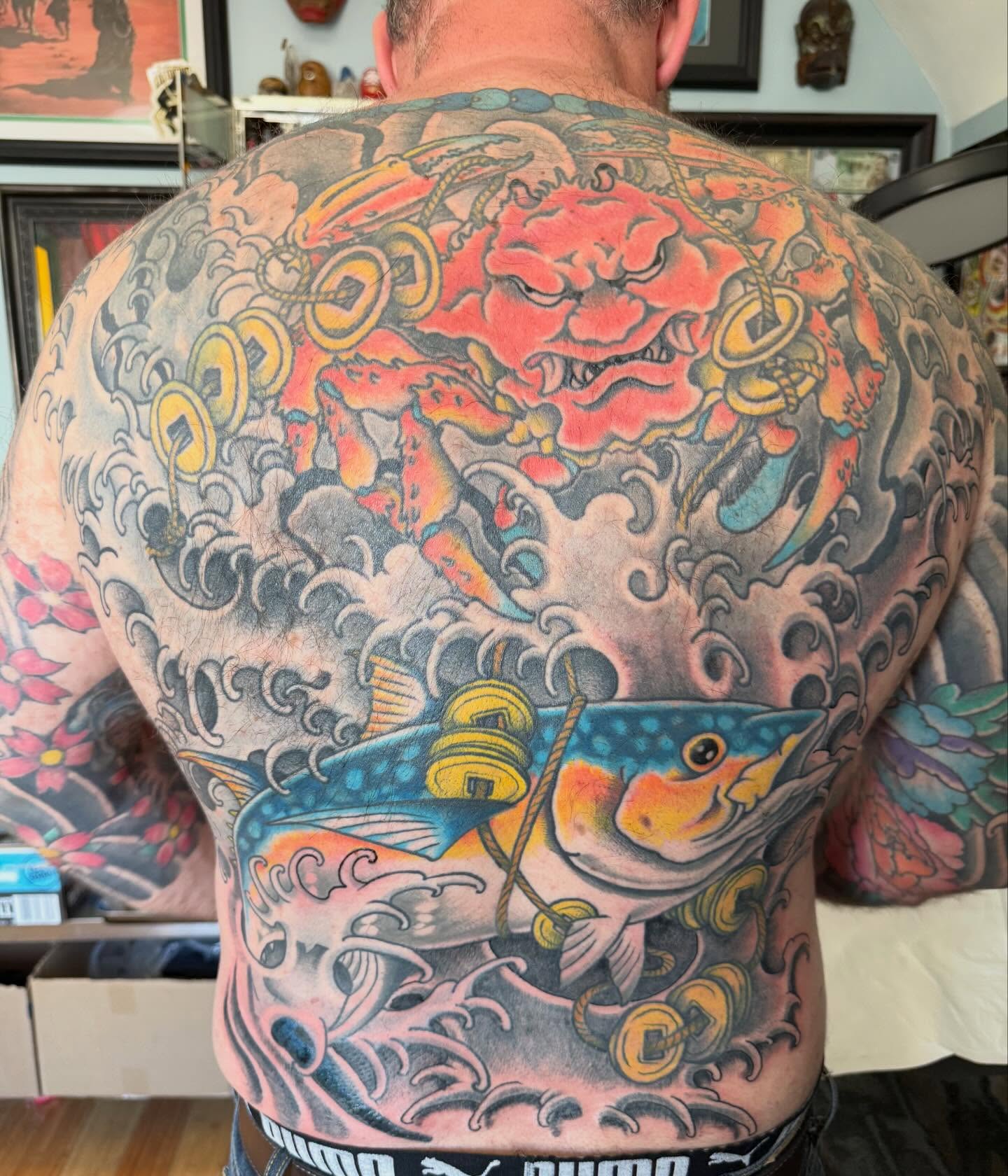 Fish and lion japanese irezumi tattoo on the back by Tony Beuke