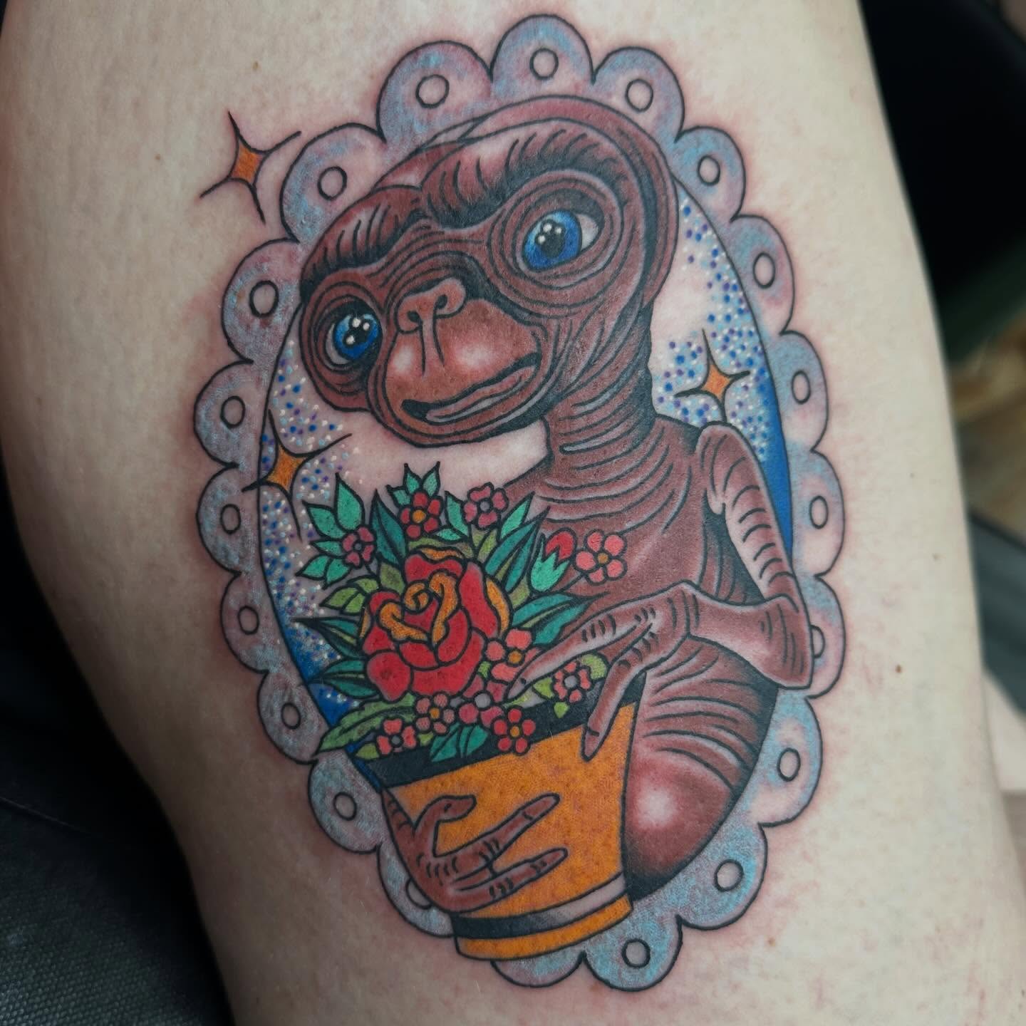 E.T American traditional tattoo on the thigh by Shaila Roach Decorative & Cosmetic Tattooer