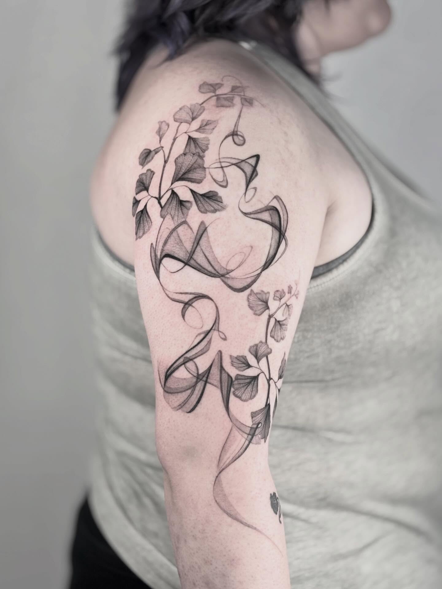 Abstract floral design fine line tattoo on the upper arm by Brittney Naami, San Francisco, California