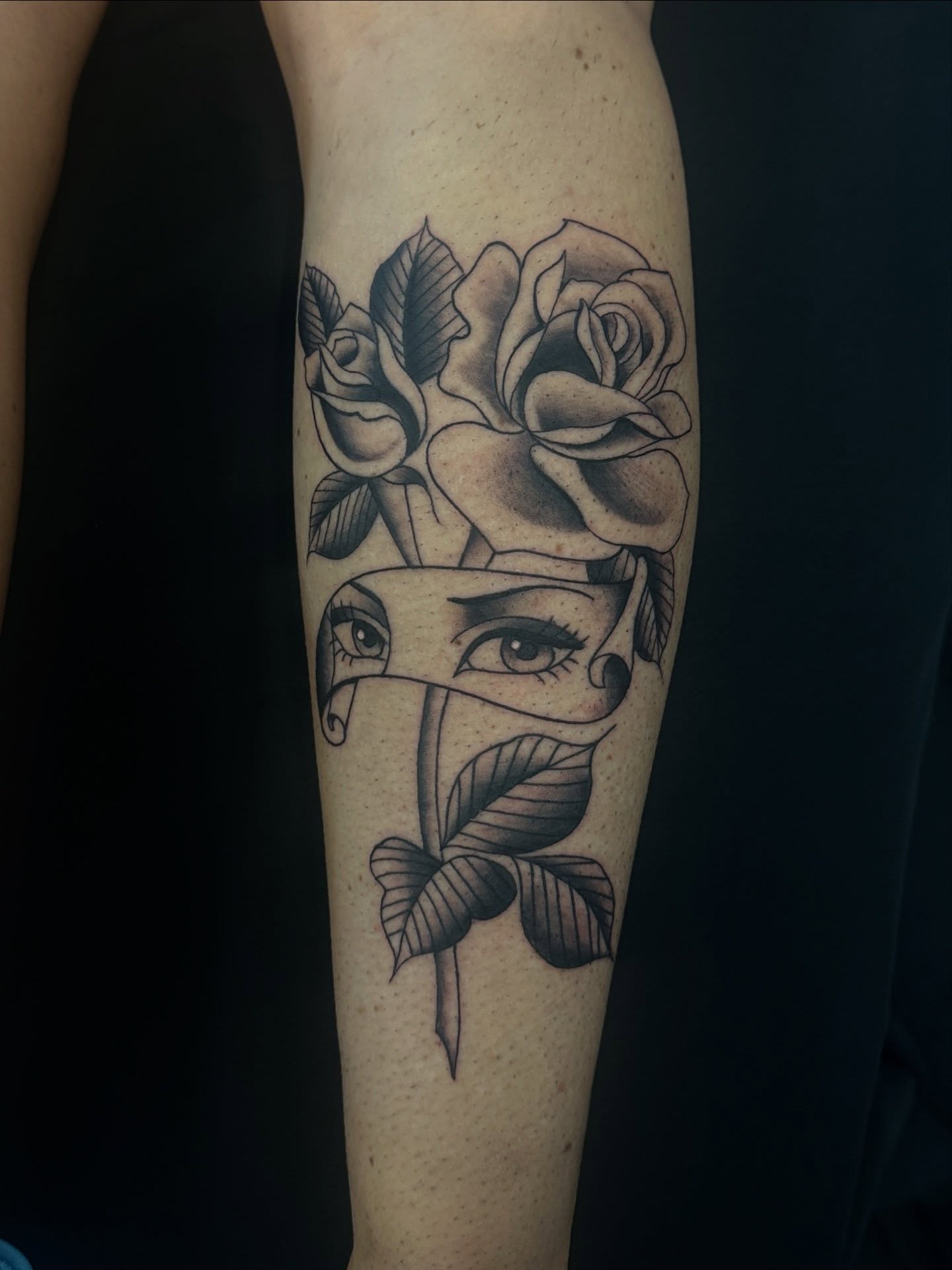 Roses and eyes realism tattoo on the forearm by Matt Kearney