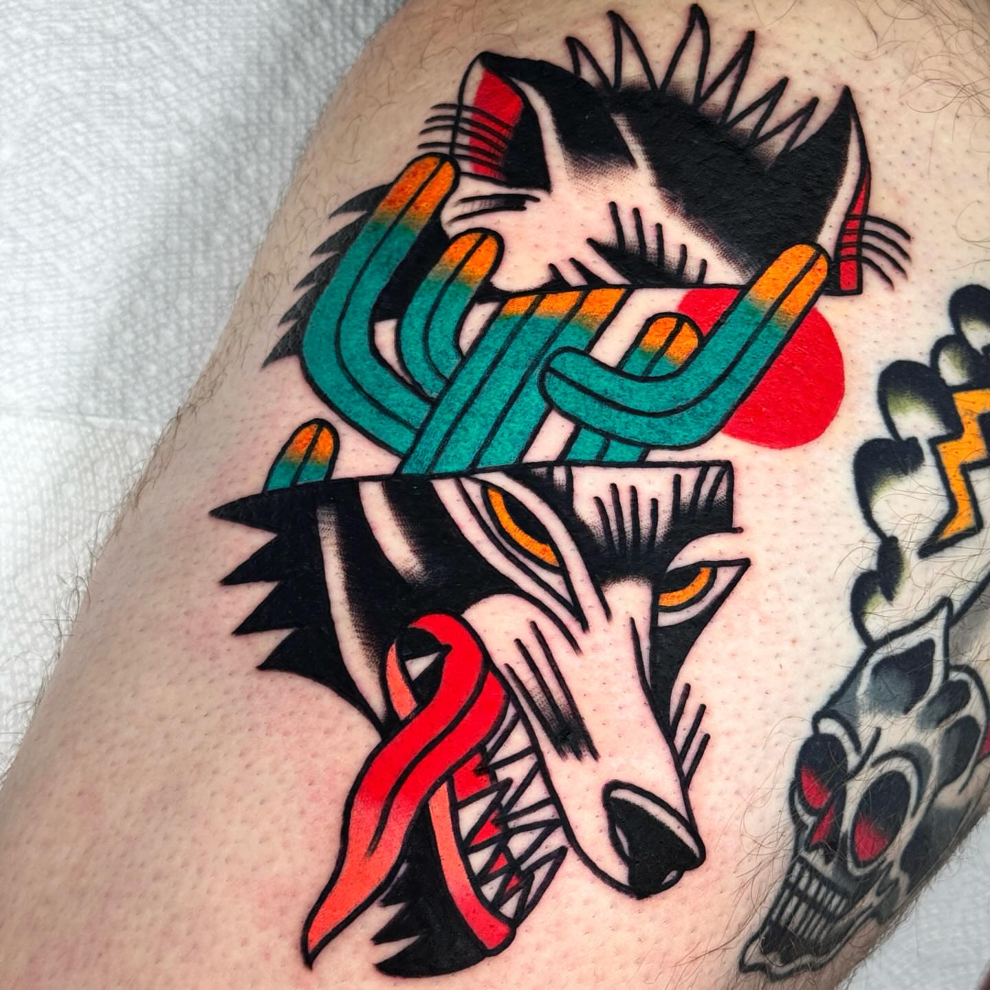 Wolf American traditional tattoo on the thigh by Jess Baker