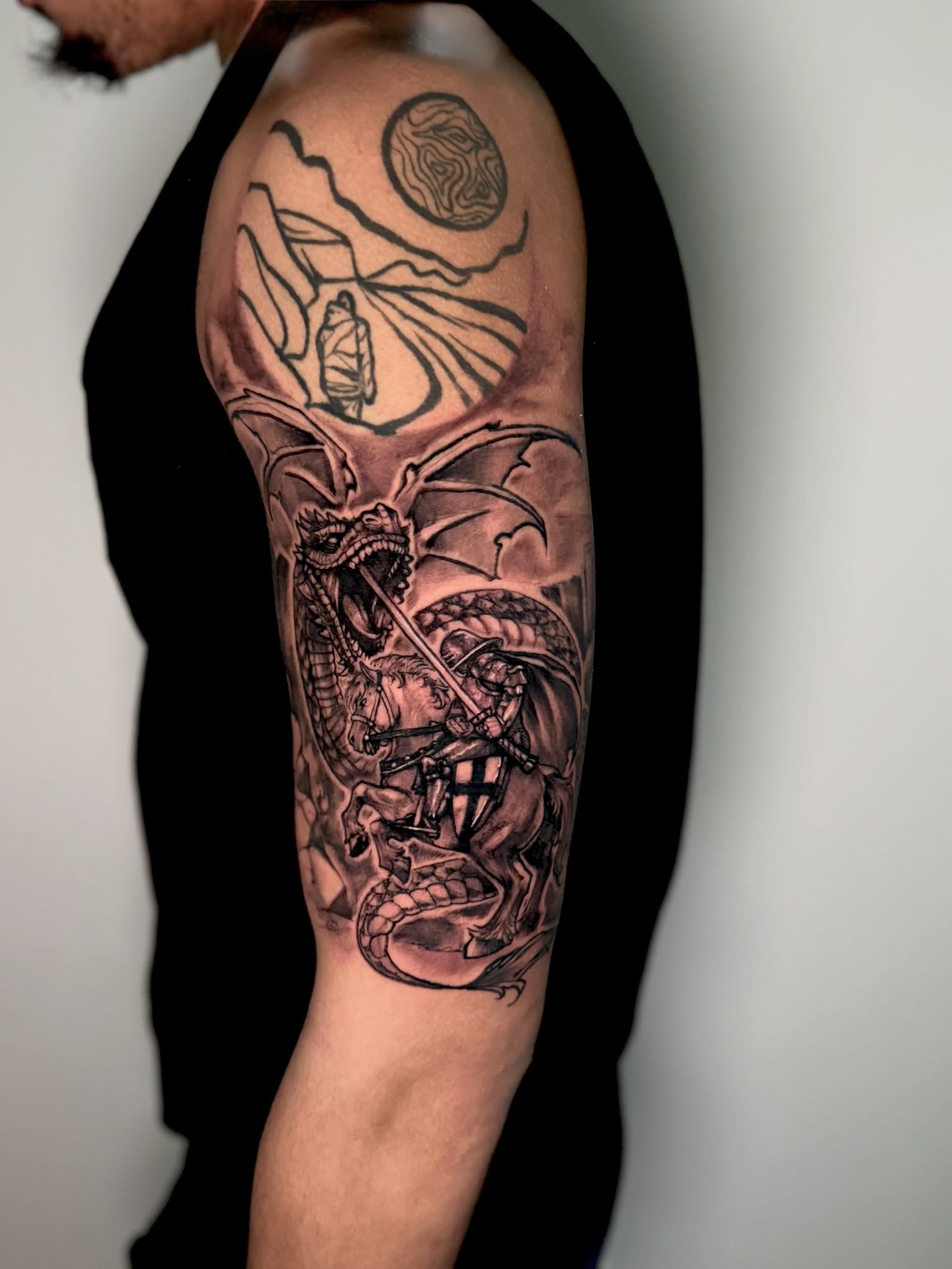 Dragon and knight realism tattoo on the forearm by Dmitrii Damoer, New York, New York