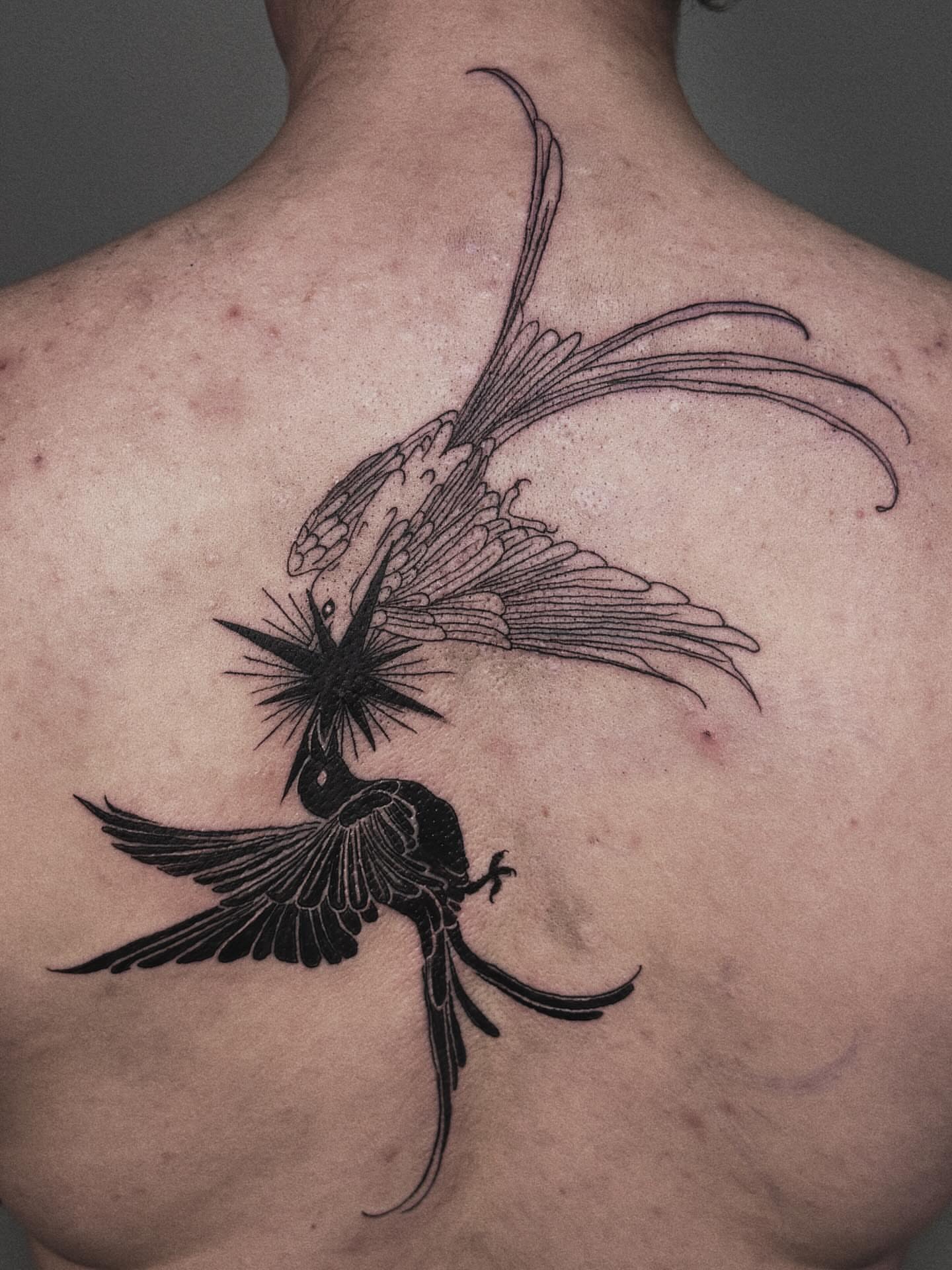 Bird black and grey tattoo on the back by Paulina Vazquez