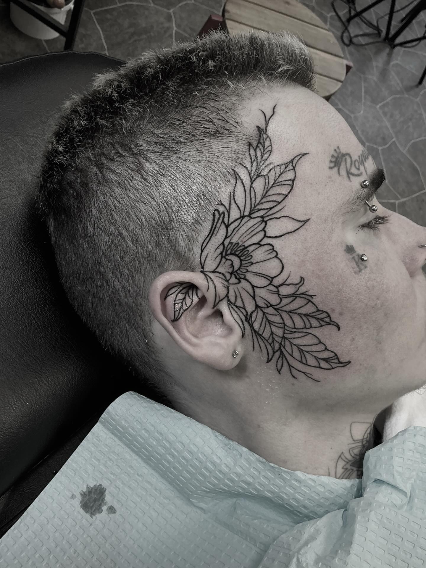 Floral design black and grey tattoo on the head by Brookelyn
