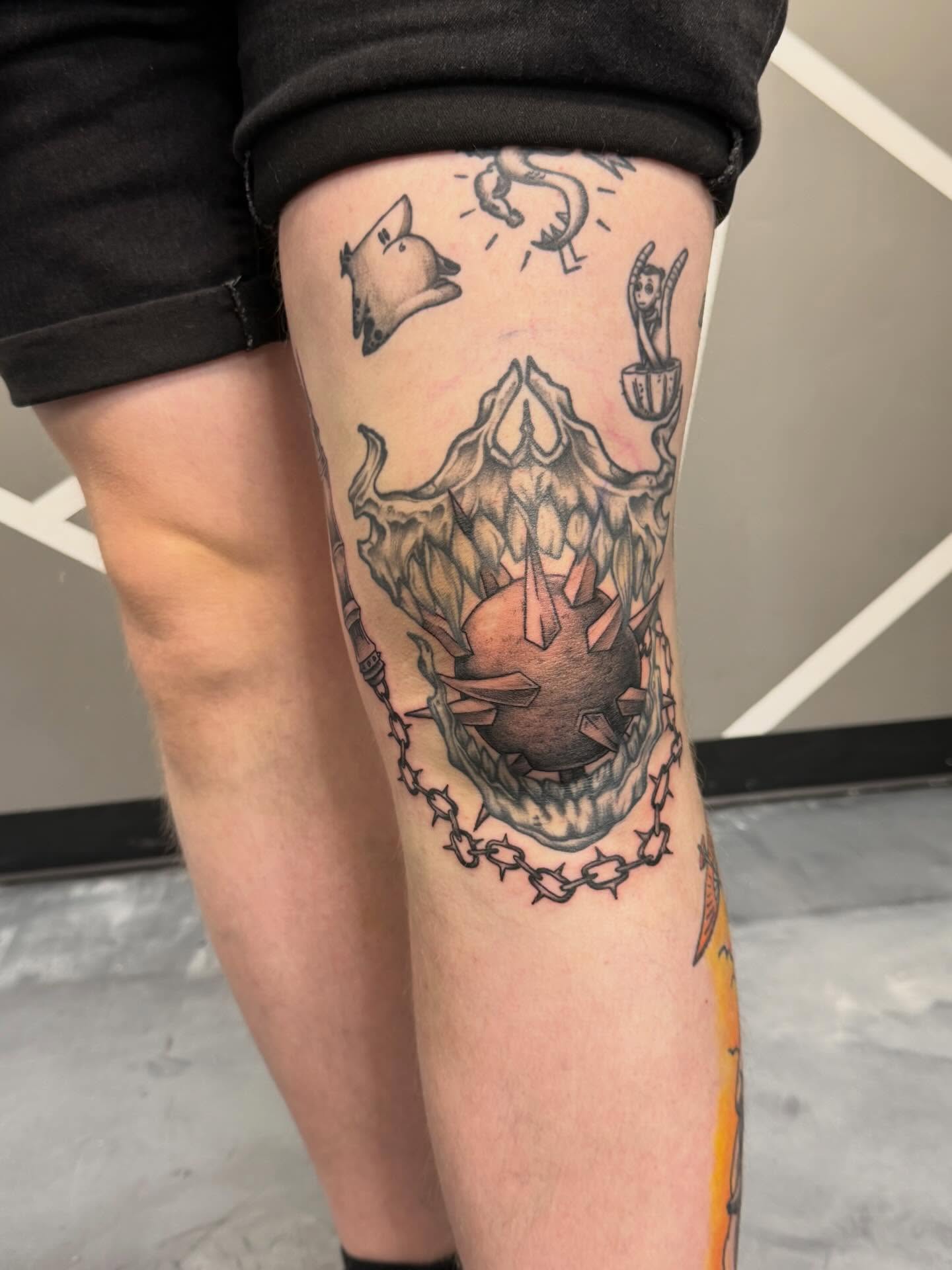 Demon skull black and grey tattoo on the thigh by Katie Rojas