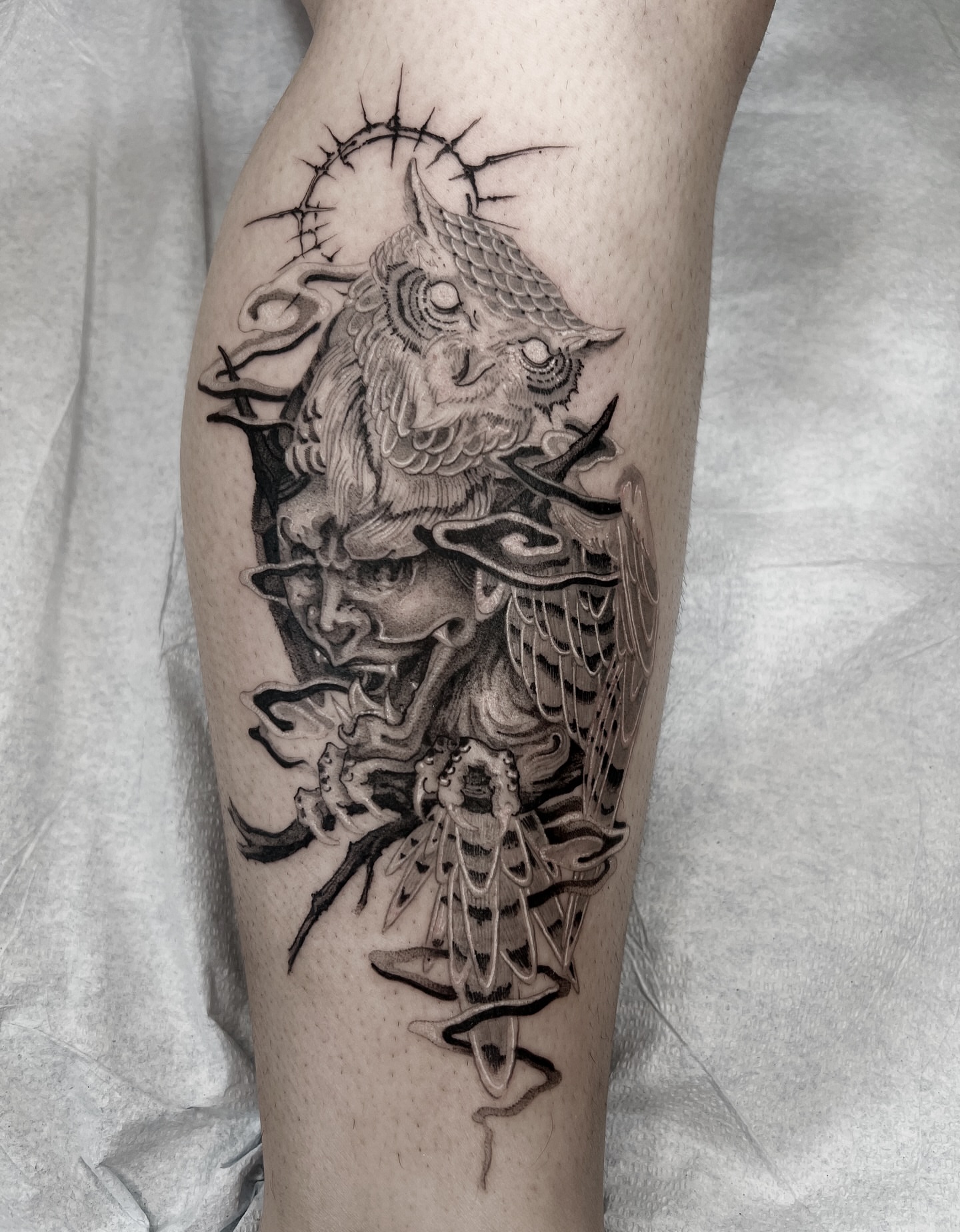 Owl and demon mask realism tattoo on the forearm by Joshua Hung, Alhambra, California