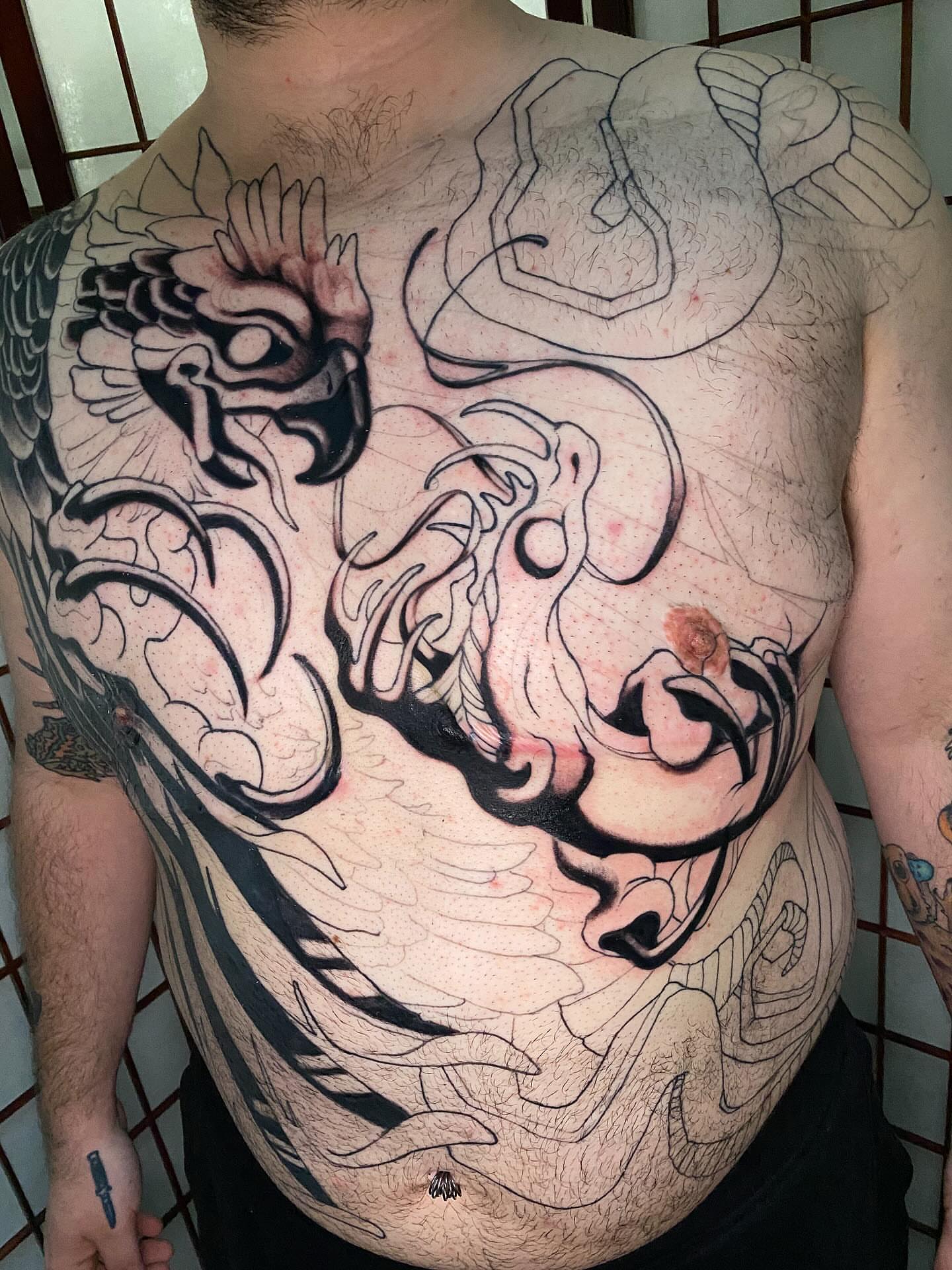 Bird black and grey tattoo on the chest by Lindsay Hall