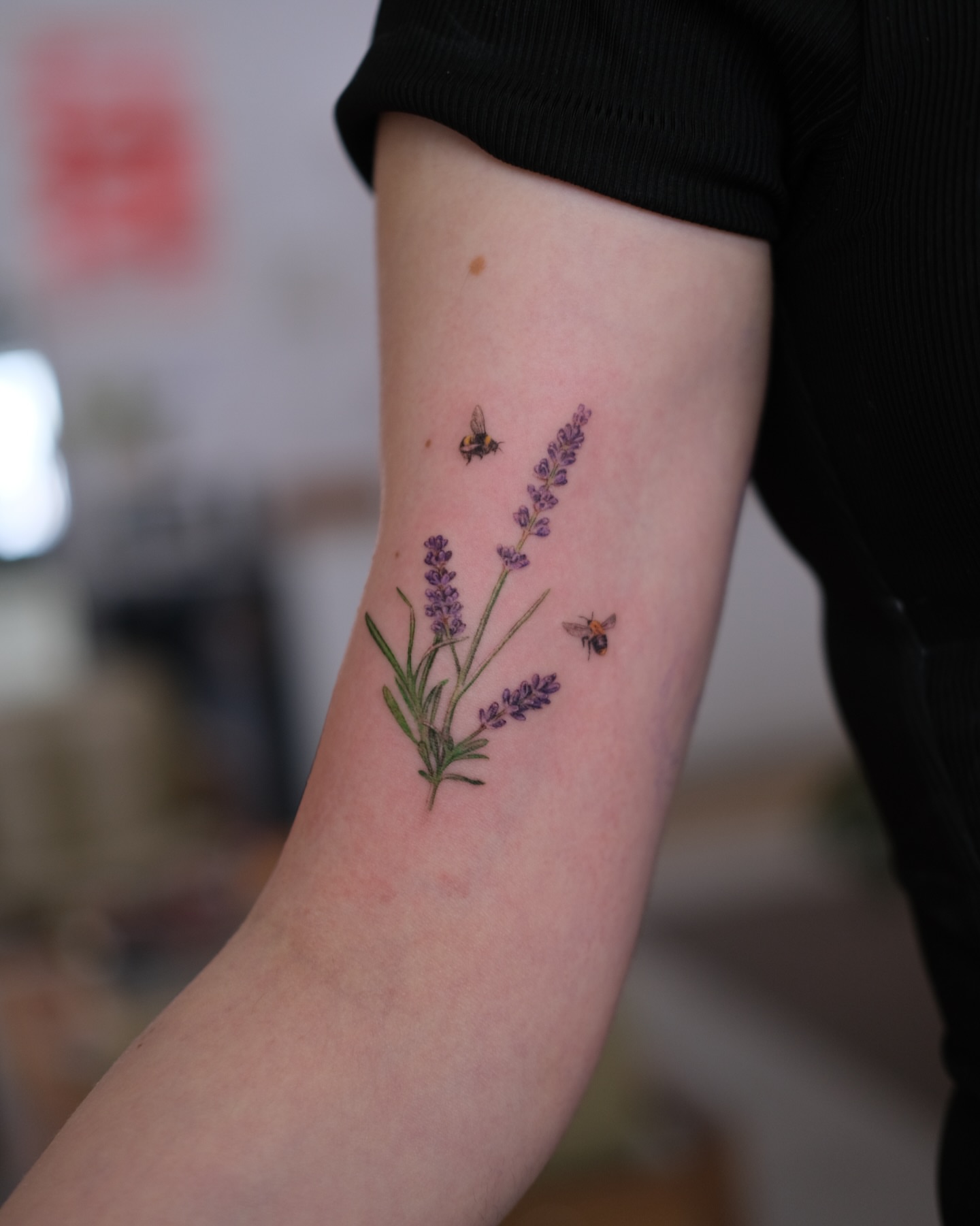 Lavender and bees realism tattoo on the forearm by Jiemin Lin