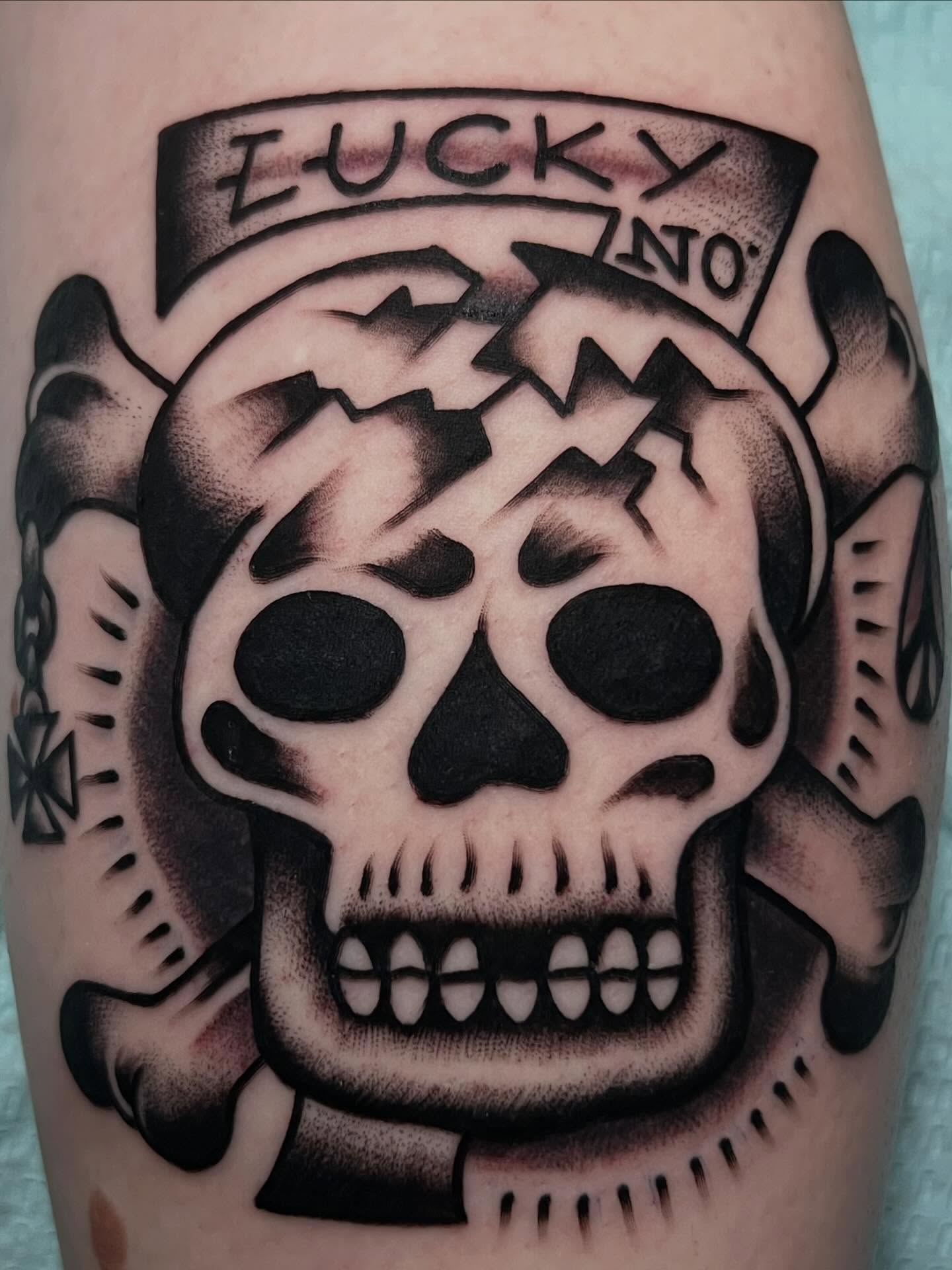 Skull with banner American traditional tattoo on the forearm by Charlie Campanella