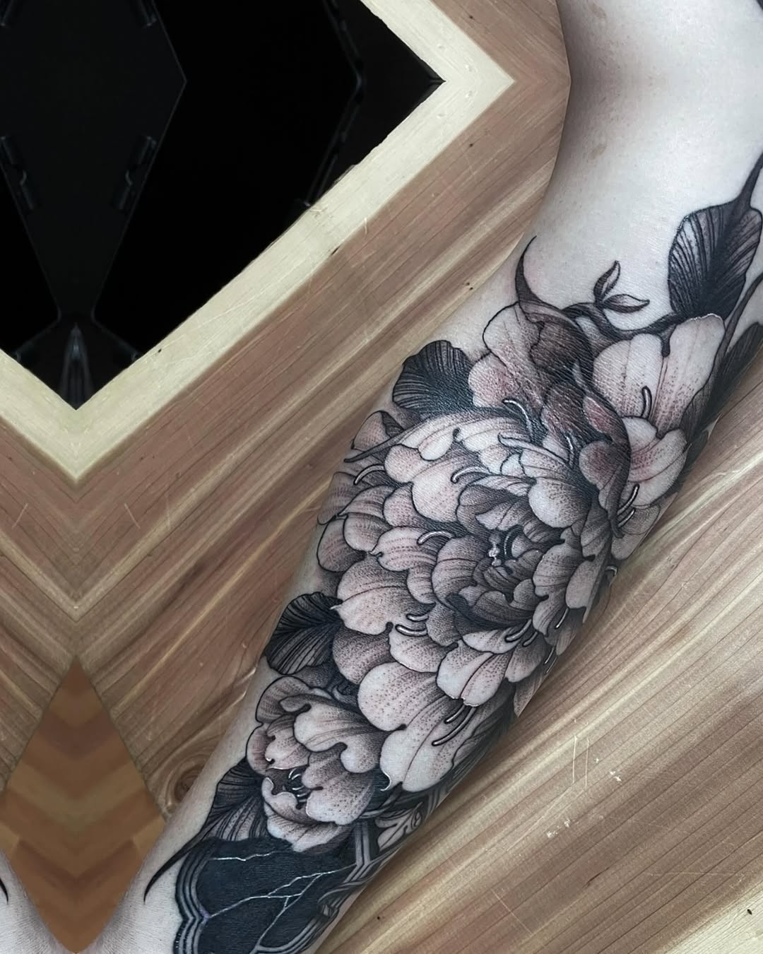 Peony flowers and leaves dotwork tattoo on the forearm by Raheem Jacobs, Austin, Texas