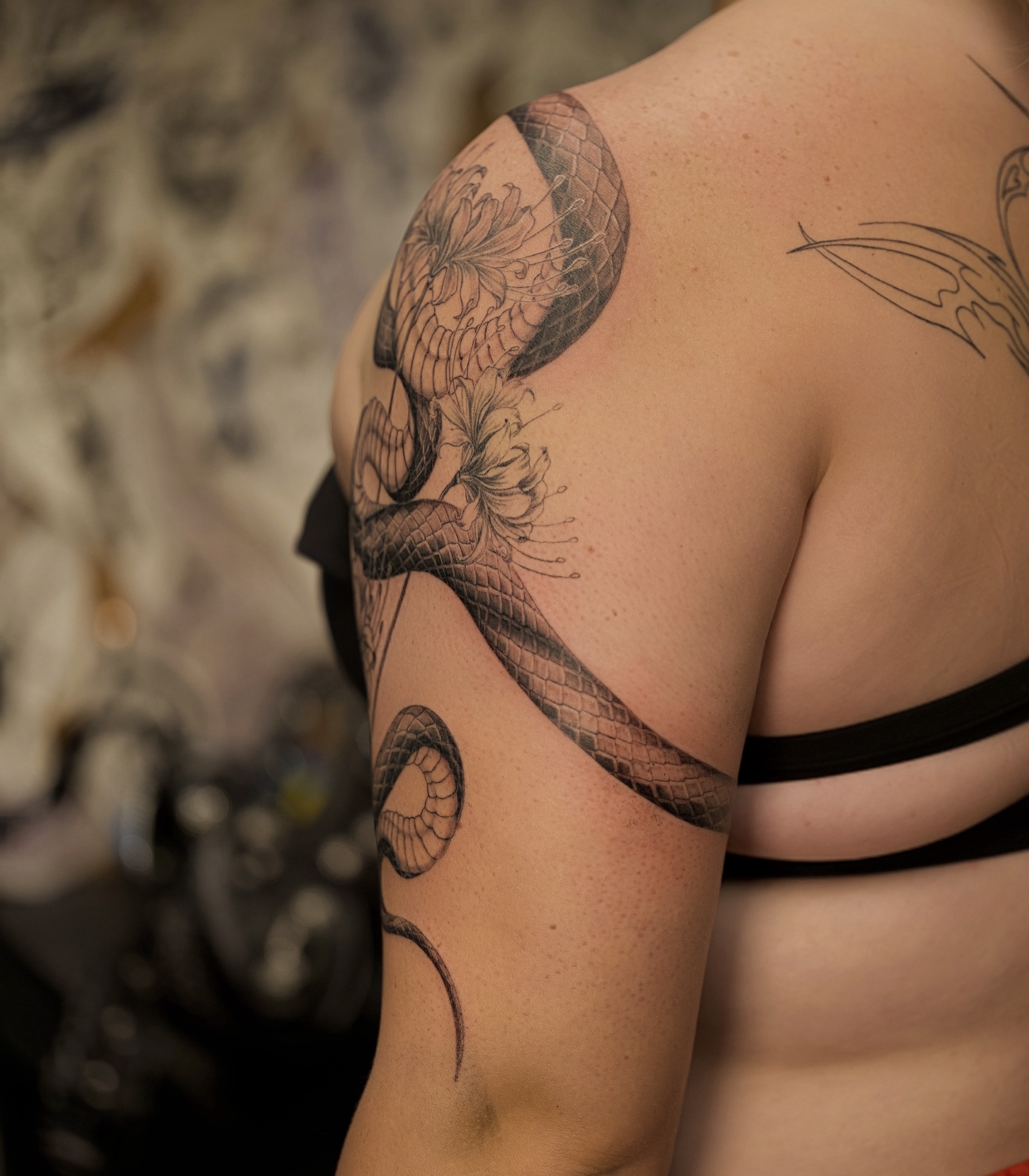 Snake and flowers realism tattoo on the shoulder by Damon_modoink