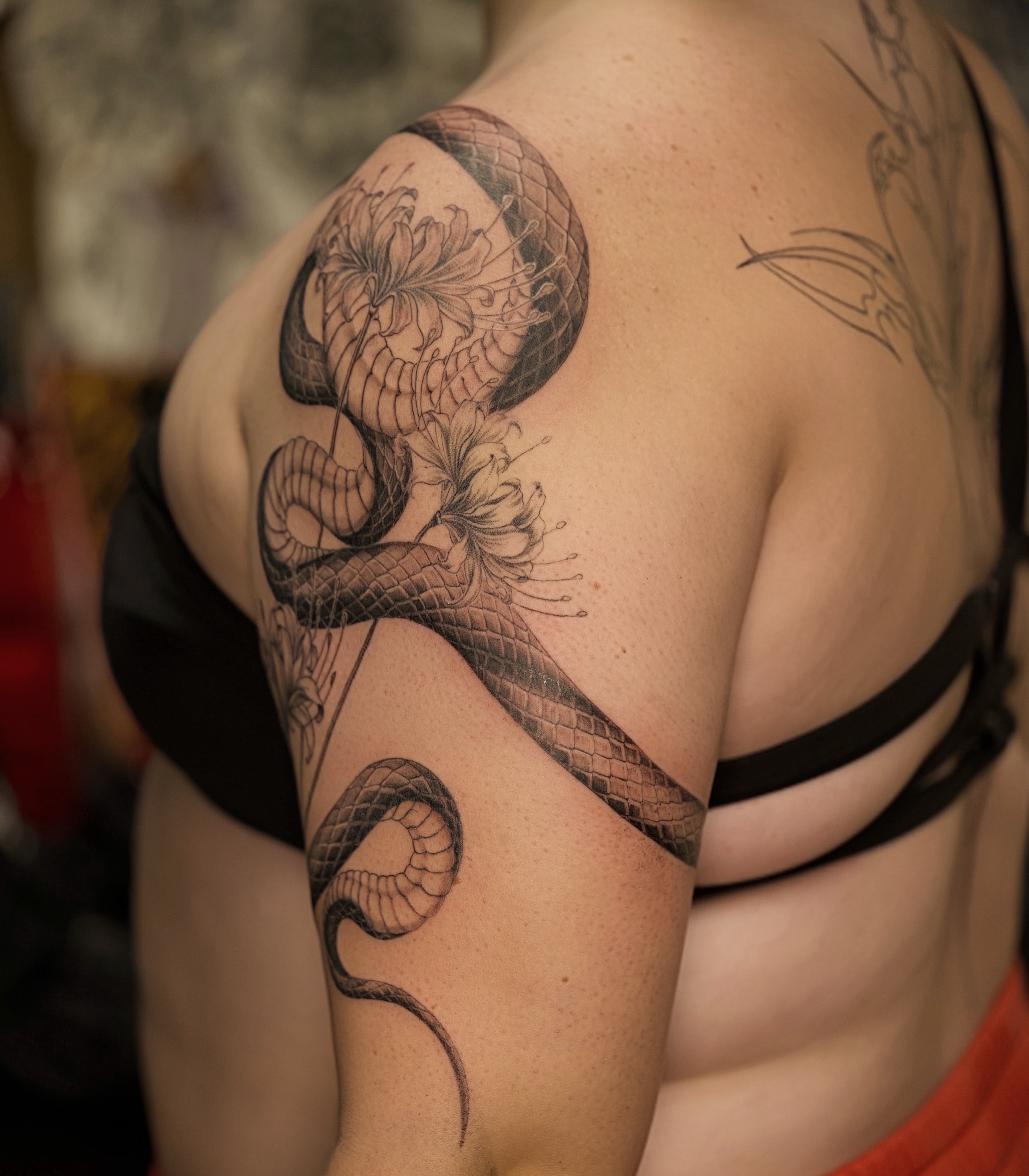 Snake and flowers realism tattoo on the shoulder by Damon_modoink