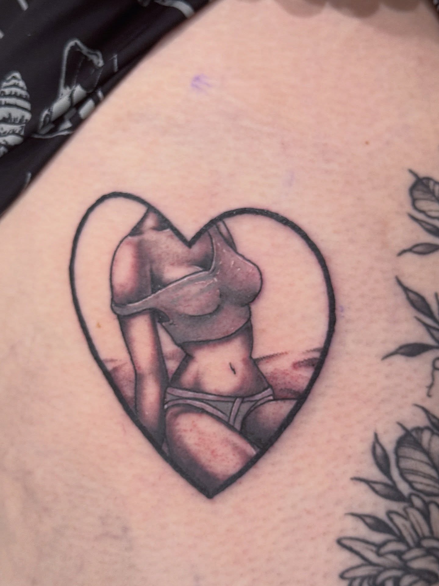 Heart with woman realism tattoo on the thigh by Brian DiCola Tattooer