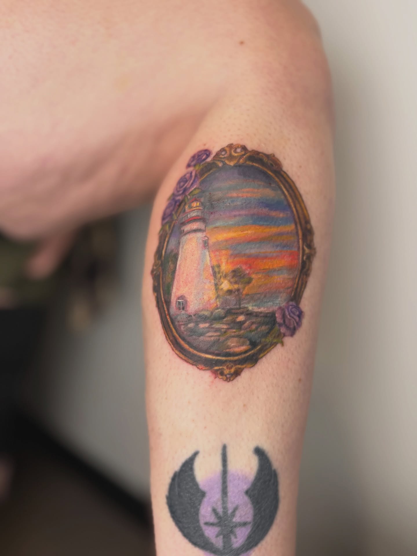 Lighthouse realism tattoo on the forearm by Mackenzie
