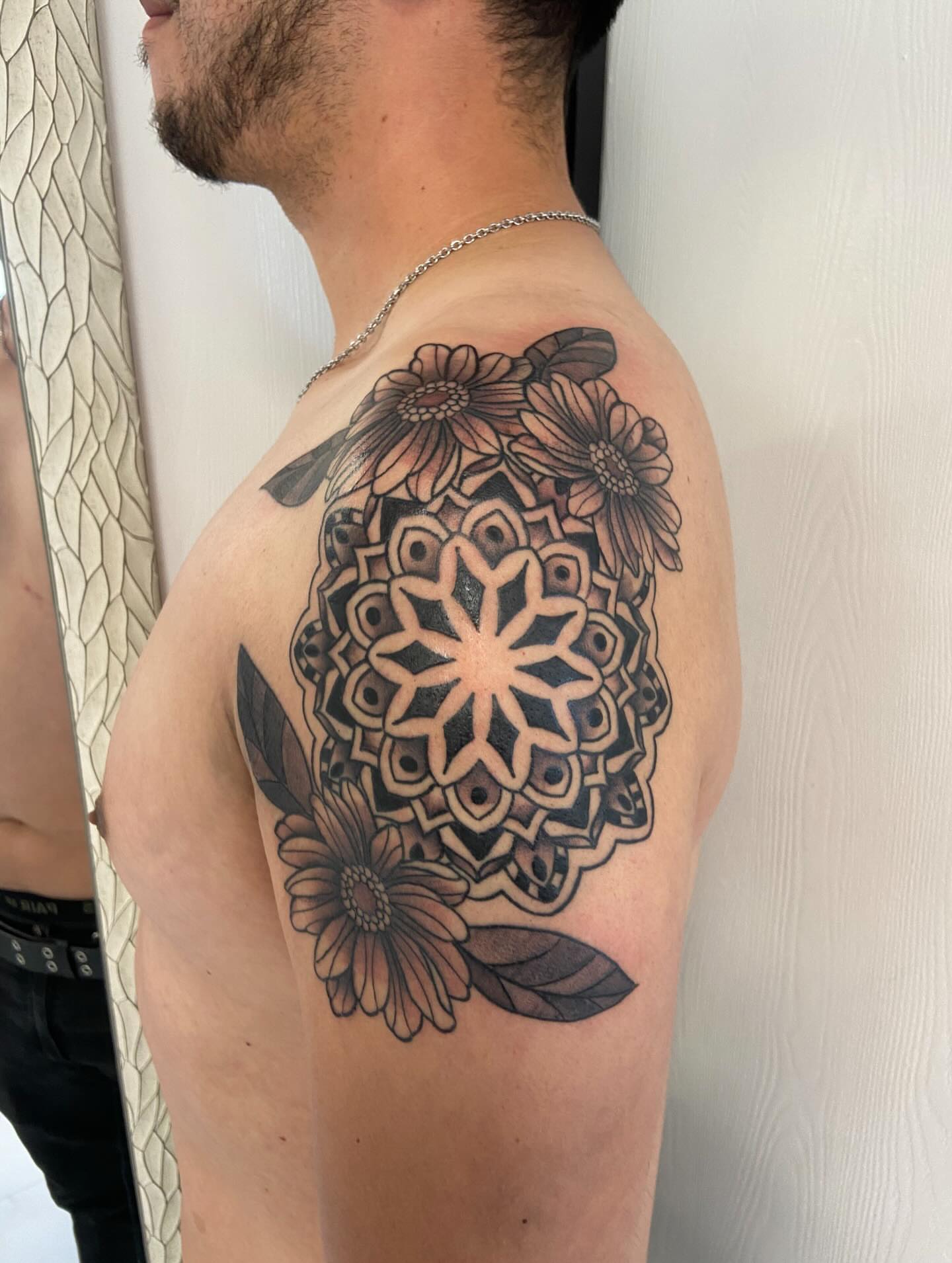 Mandala with flowers geometric tattoo on the shoulder by Sophia