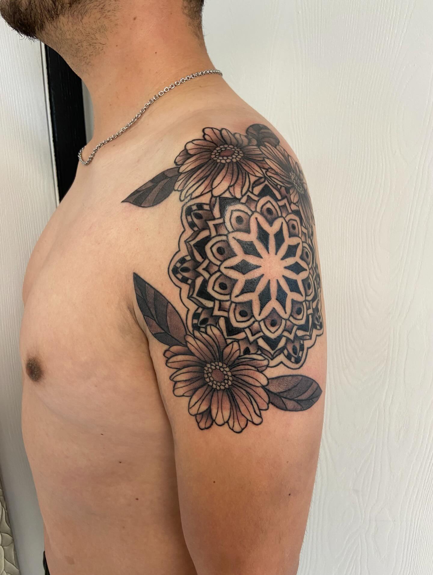 Mandala with flowers geometric tattoo on the shoulder by Sophia