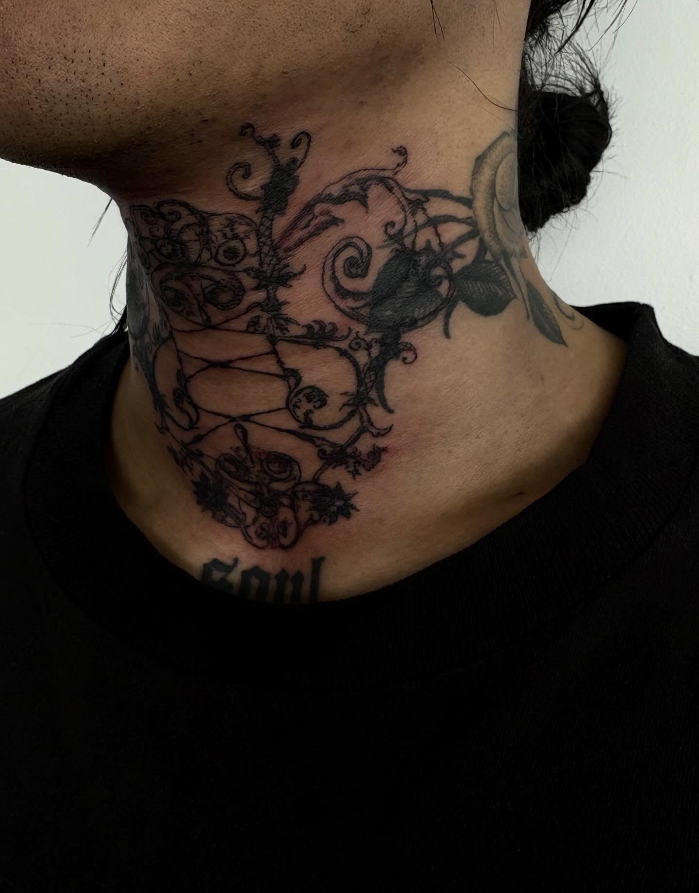 Abstract design black and grey tattoo on the neck by madeline