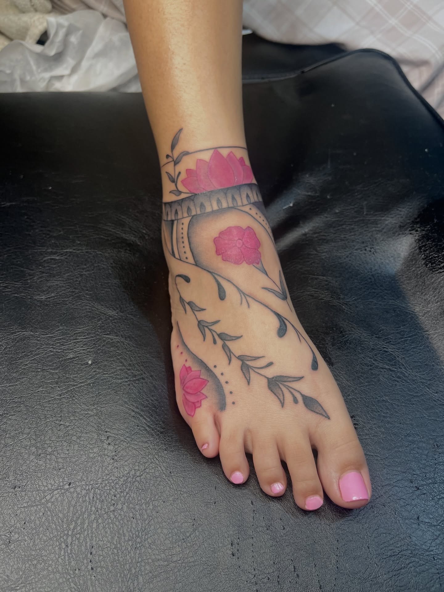 Lotus flowers dotwork tattoo on the foot by The inspo