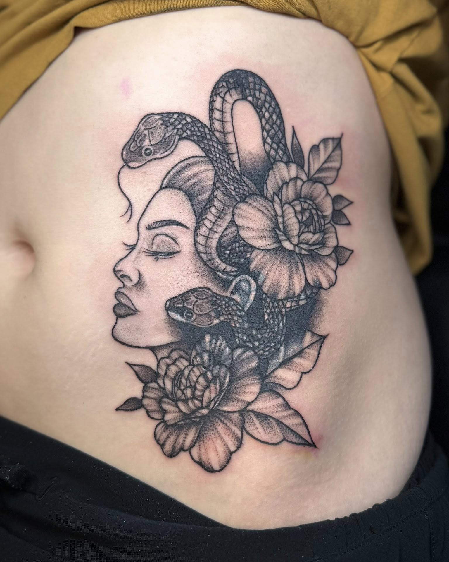 Woman with snakes and flowers dotwork tattoo on the ribs by Eden Rose, Kalama, Washington