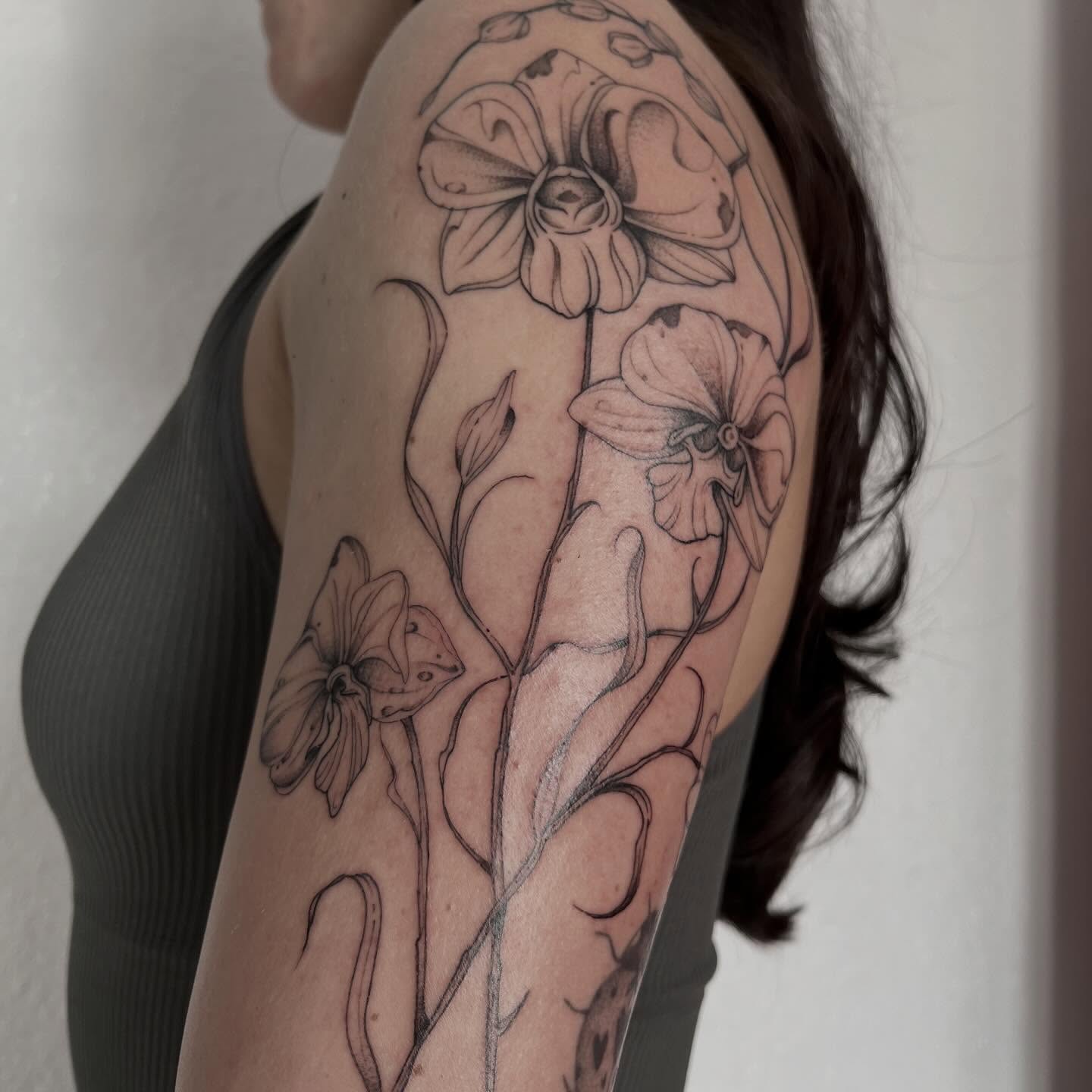 Orchids black and grey tattoo on the shoulder by Sara Atamian, San Diego, California