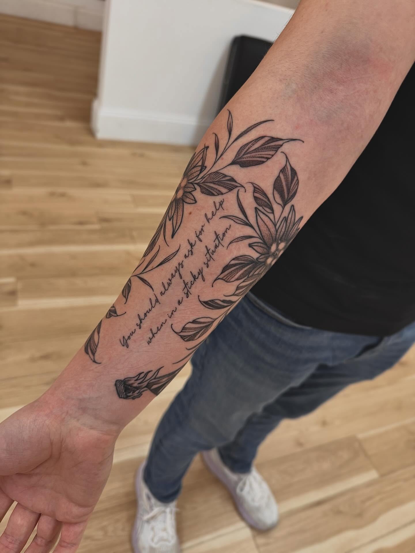 Floral design black and grey tattoo on the forearm by Stefany