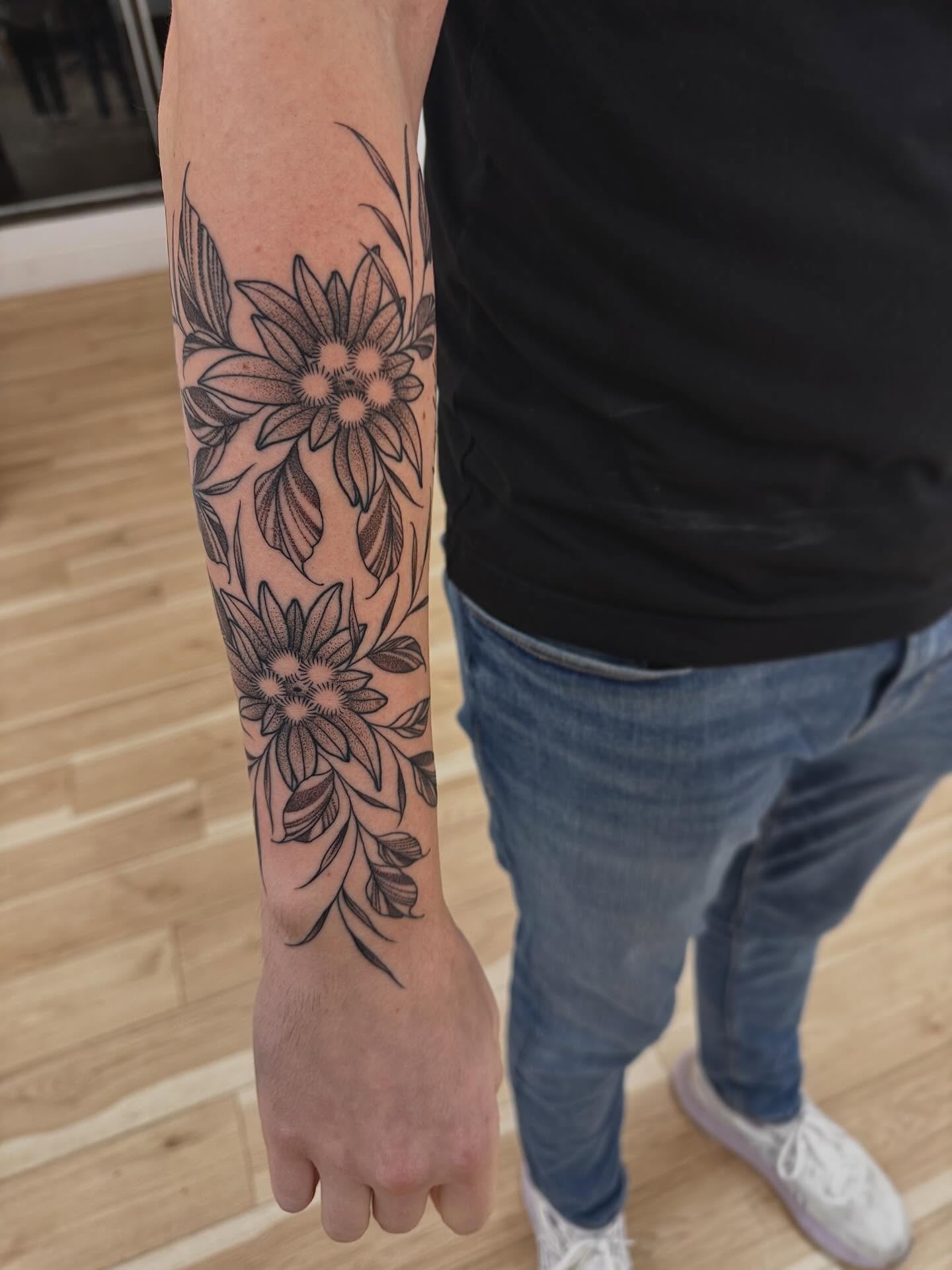 Floral design black and grey tattoo on the forearm by Stefany