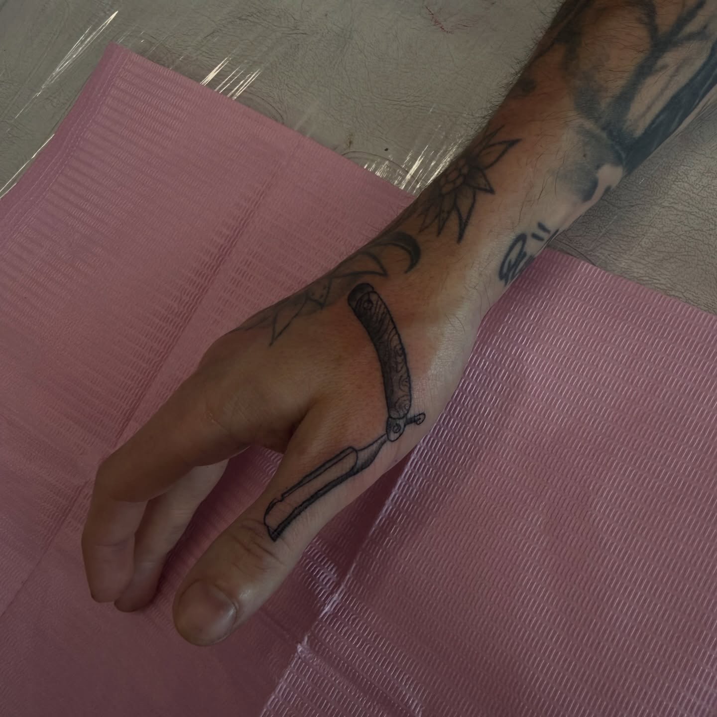 Razor black and grey tattoo on the forearm by Nina Nichole