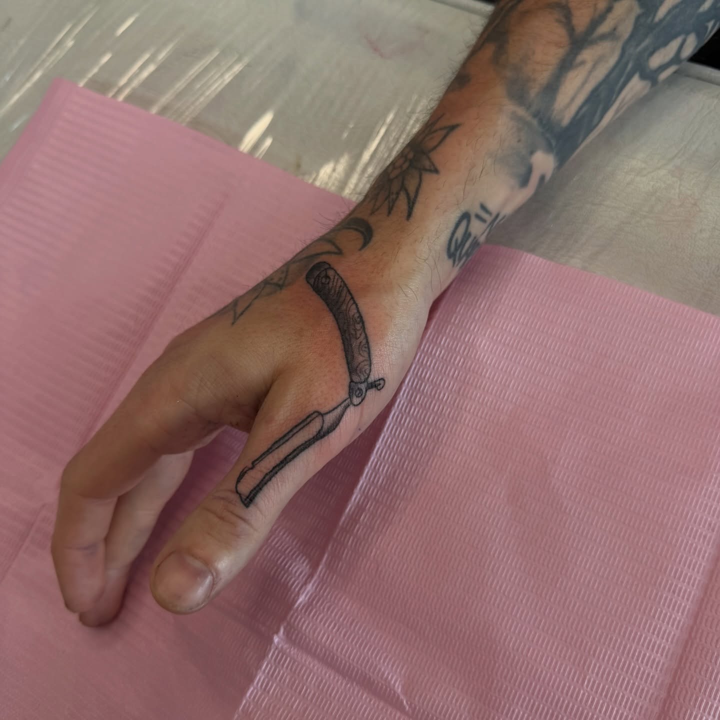 Scissors black and grey tattoo on the hand by Nina Nichole