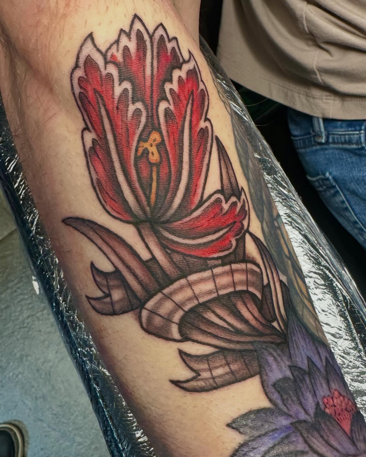 Floral arrangement American traditional tattoo on the forearm by Mikaila Jean