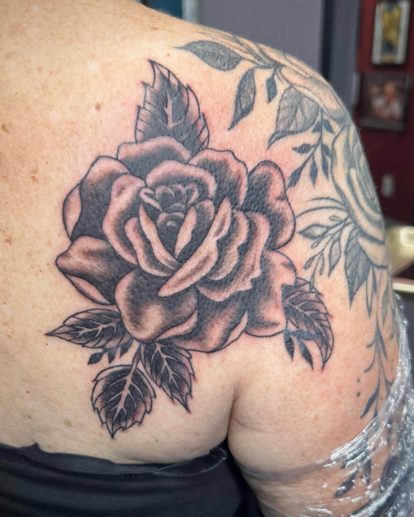 Rose black and grey tattoo on the shoulder by Mikaila Jean