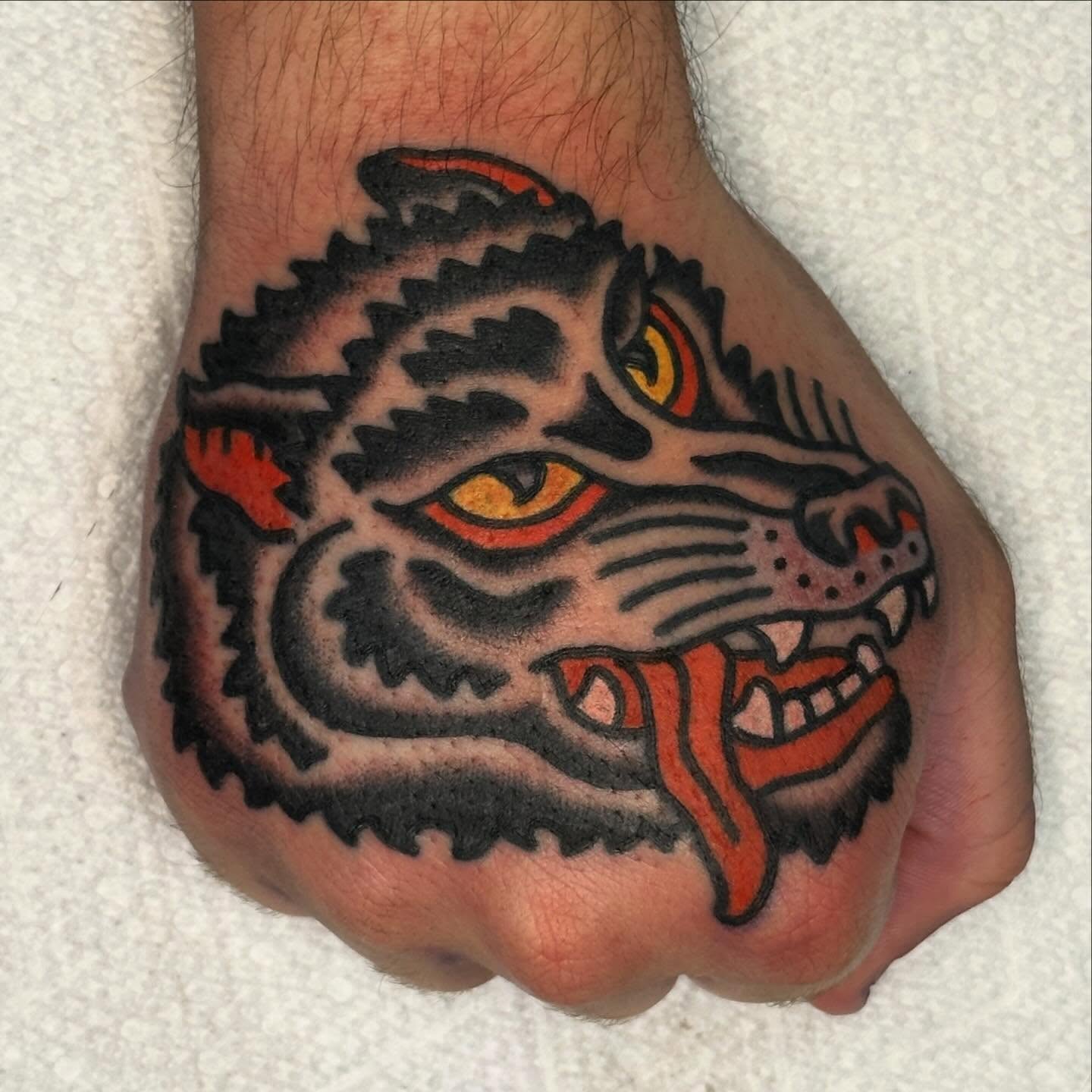 Jaguar American traditional tattoo on the hand by Rob, Nashville, Tennessee
