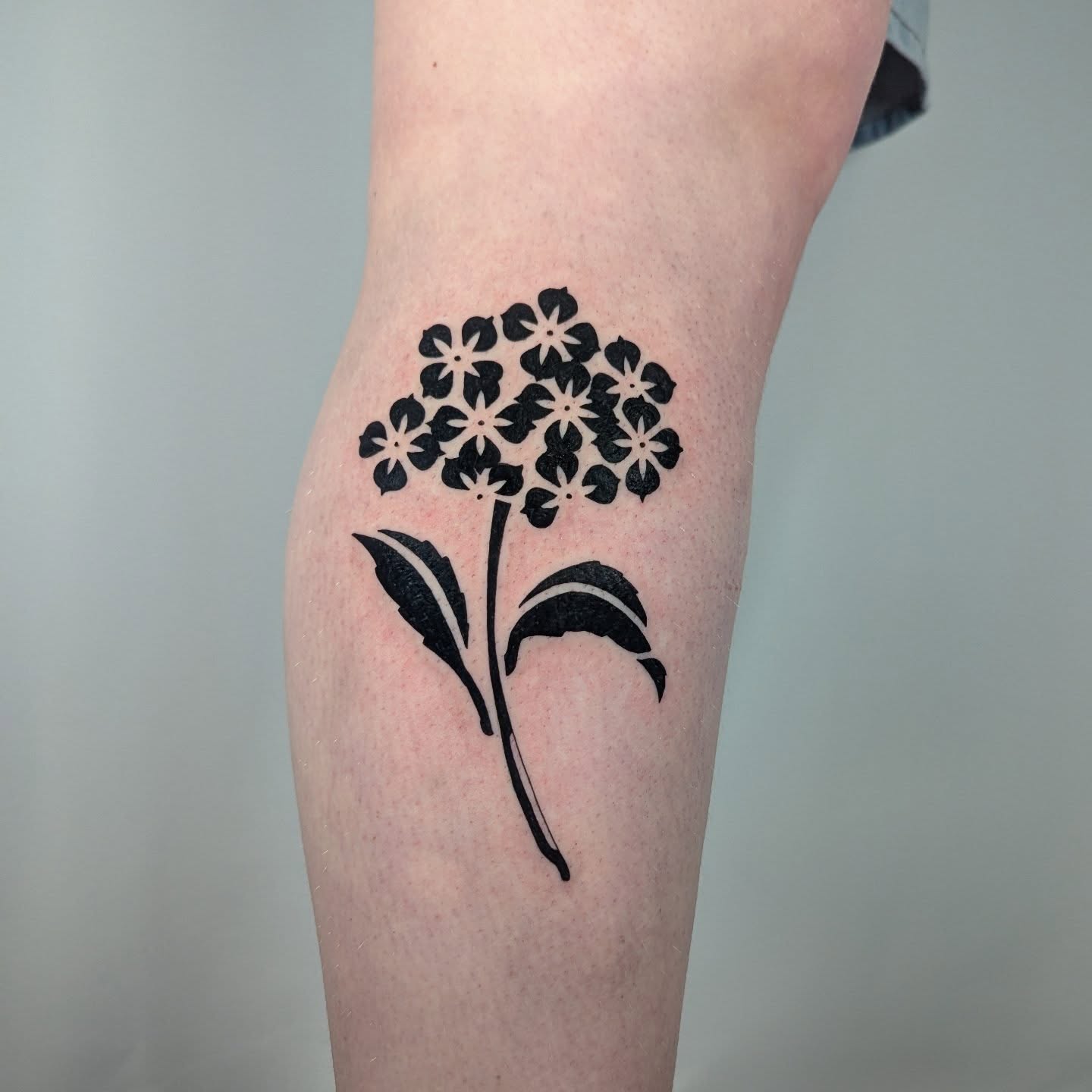 Flower bouquet black and grey tattoo on the forearm by Courtney Yaddof