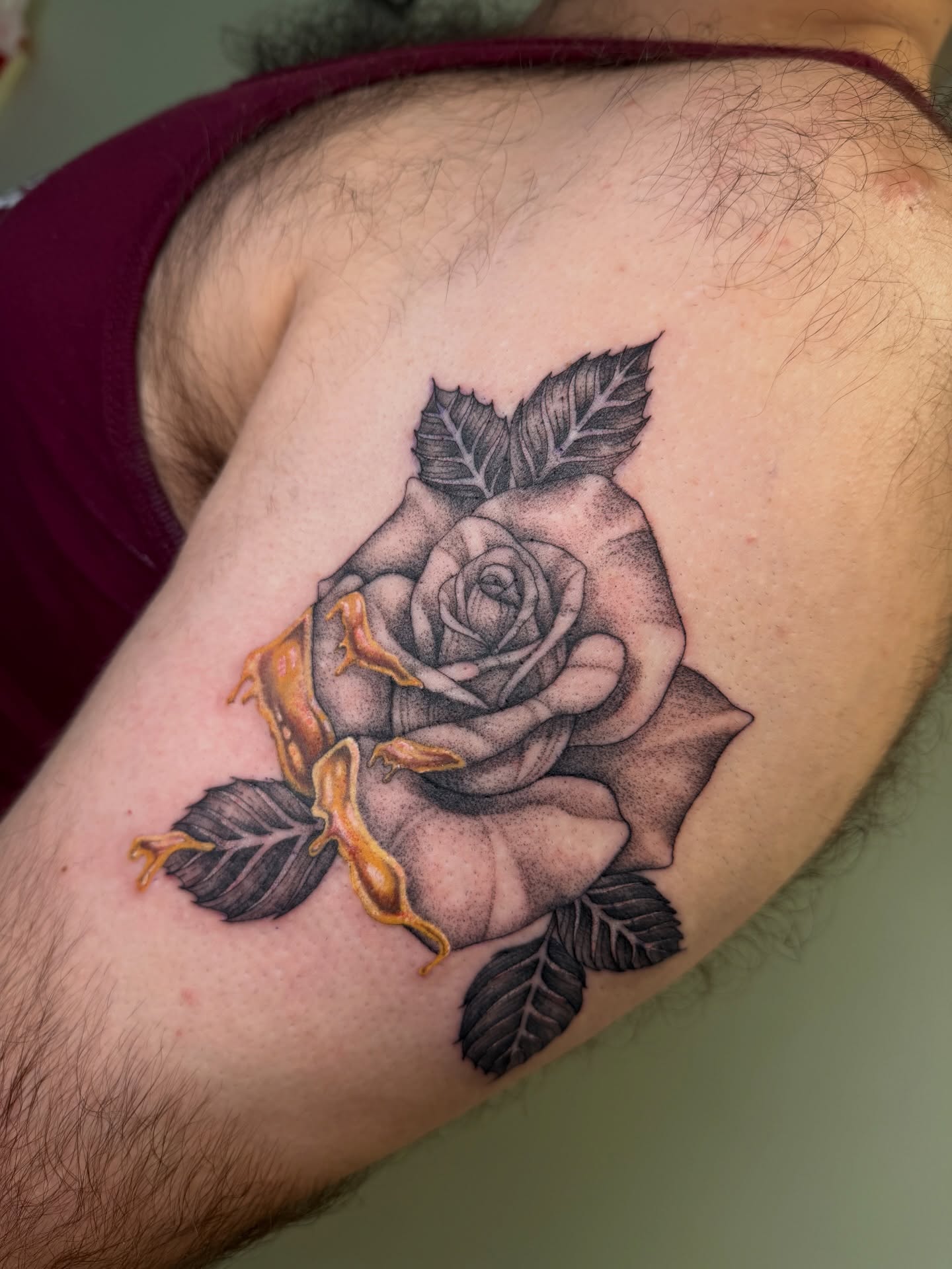 Rose realism tattoo on the upper arm by Koryn Donnelly