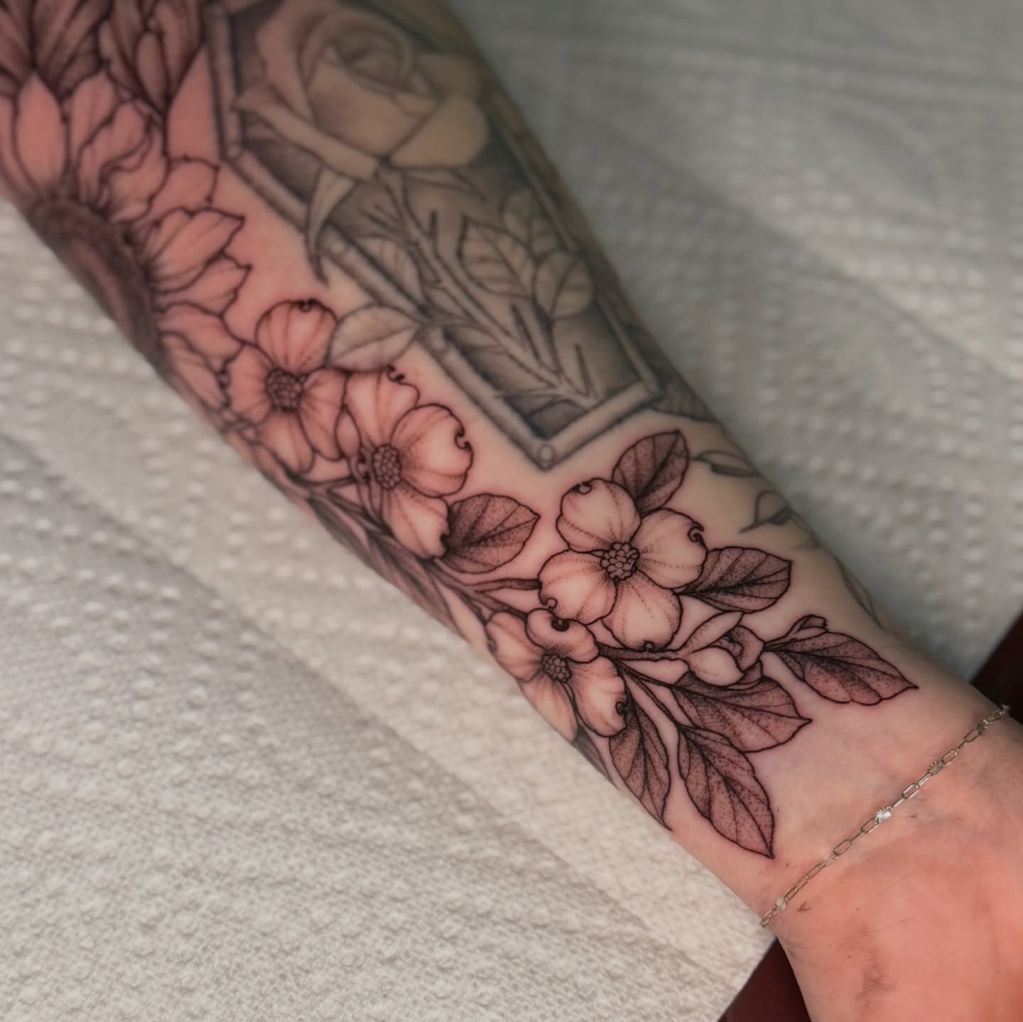 Dogwood flowers black and grey tattoo on the forearm by Chiah