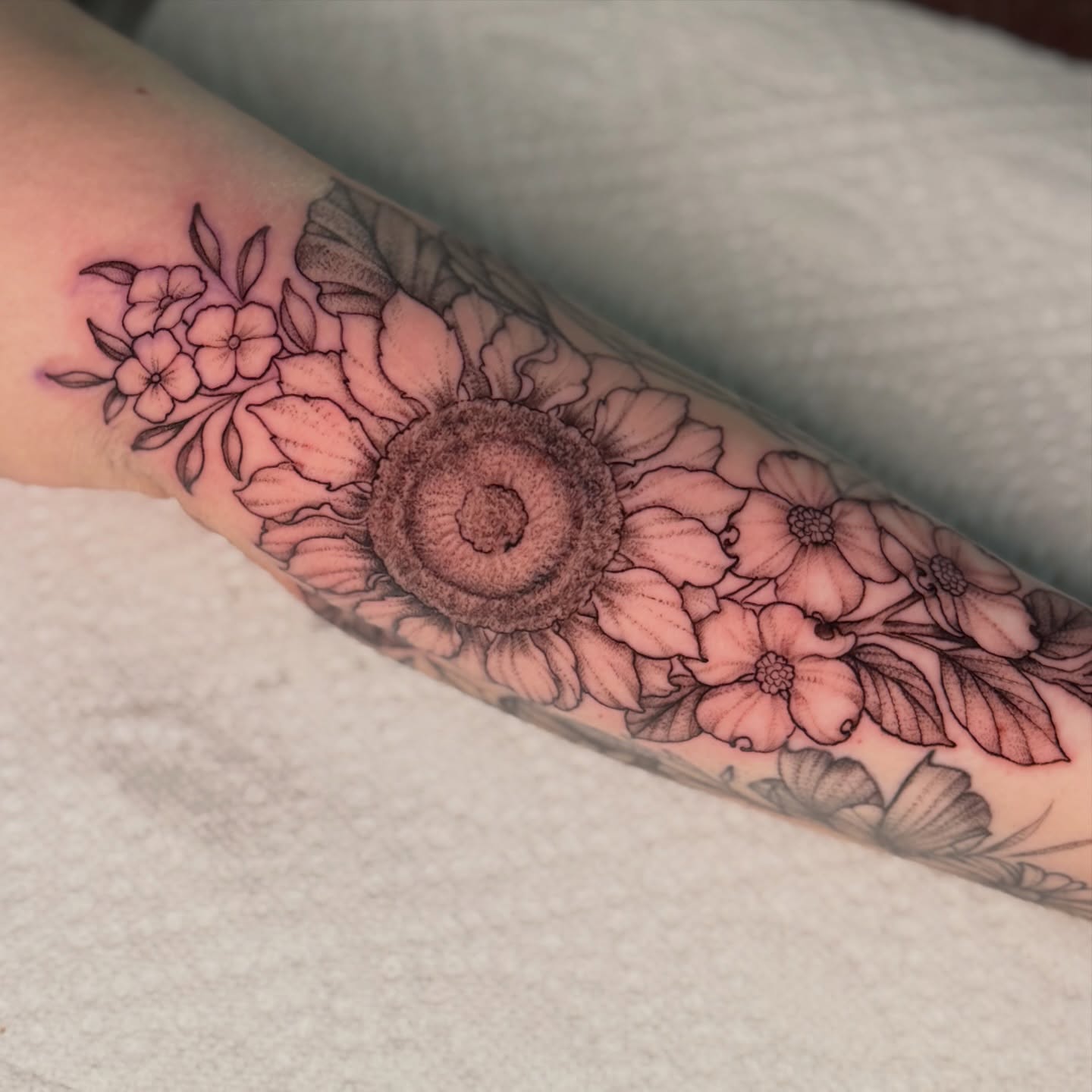 Sunflower and flowers dotwork tattoo on the forearm by Chiah