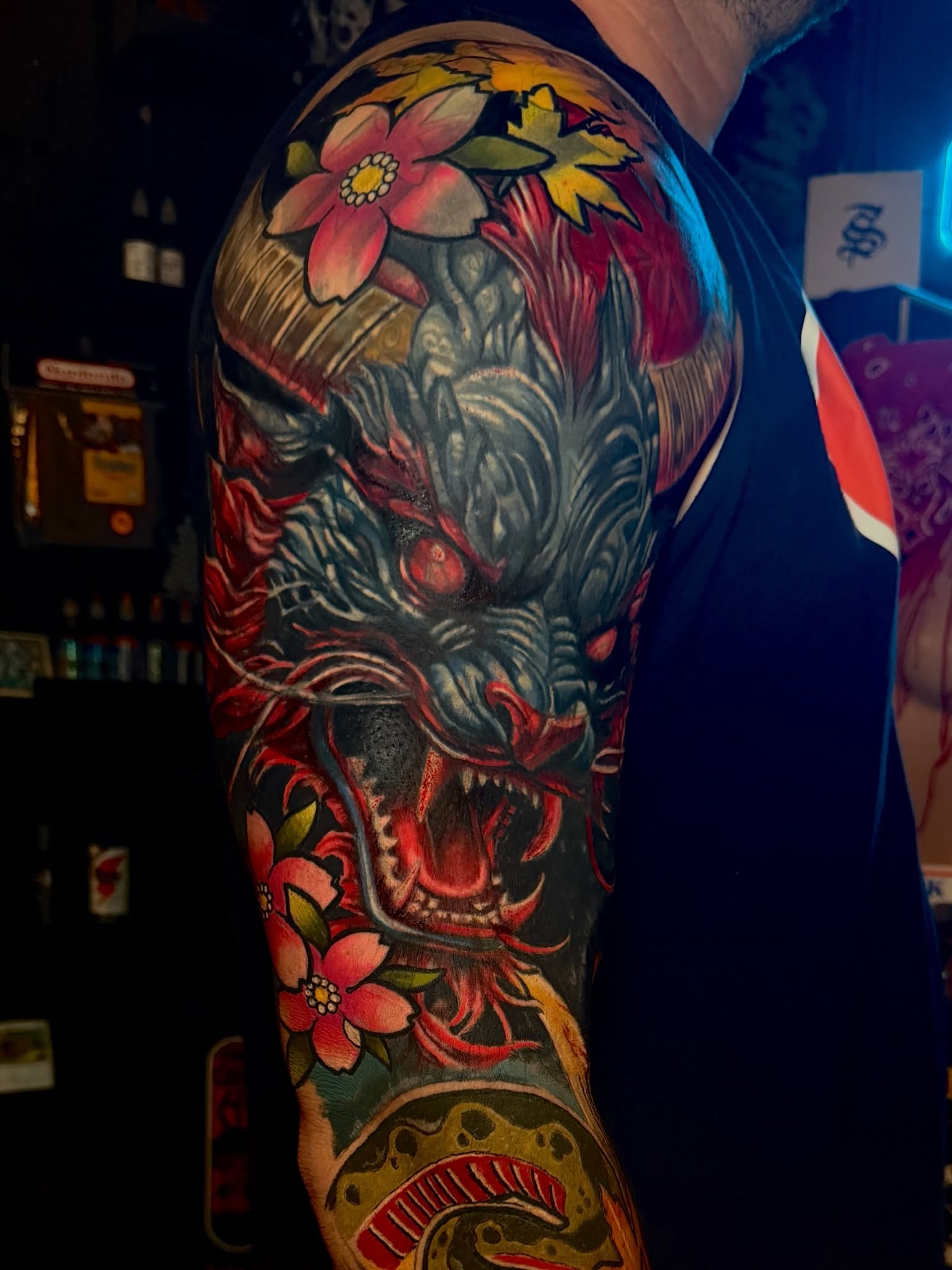 Dragon and flowers japanese irezumi tattoo on the upper arm by Scott Pizer