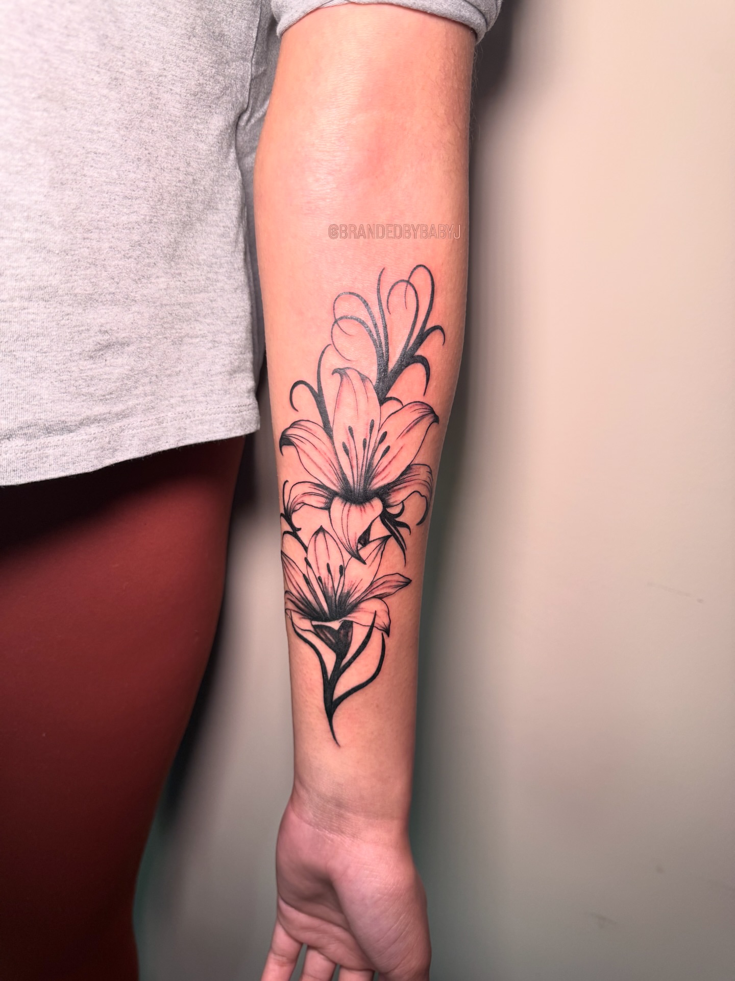 Lilies black and grey tattoo on the forearm by 𝔹𝔸𝔹𝕐 𝕁 ♡, Cincinnati, Ohio