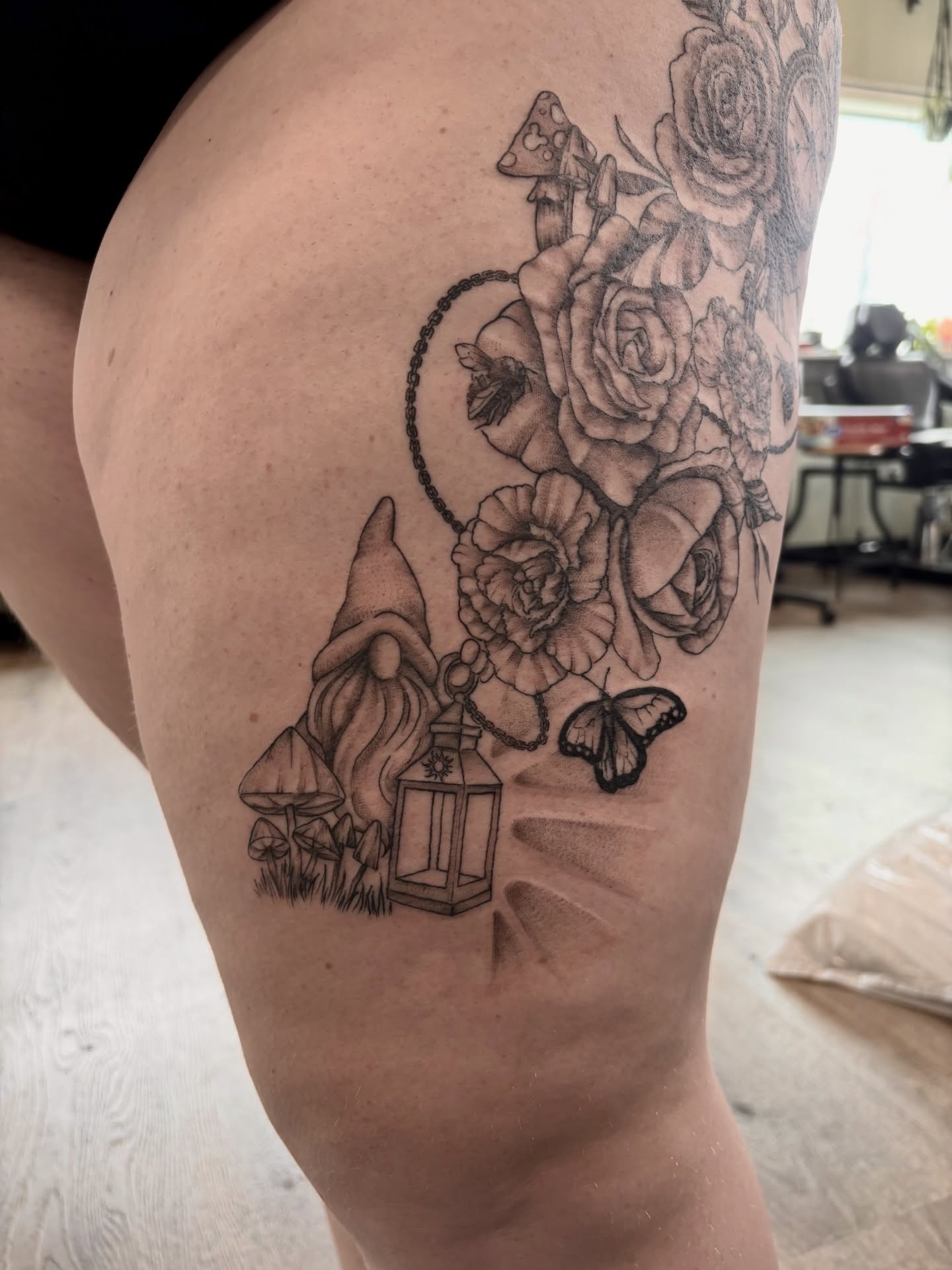 Gnome with lantern and flowers realism tattoo on the thigh by Sage Ray ♡