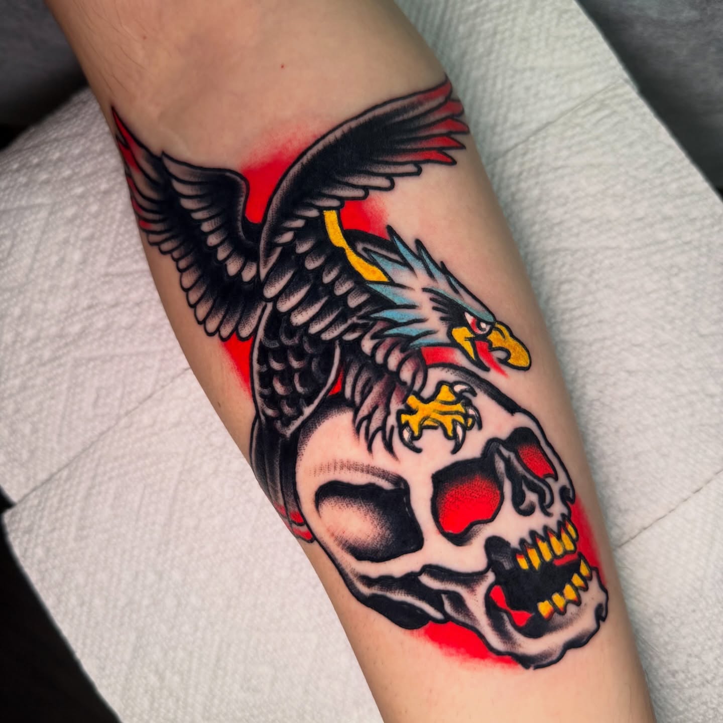 Eagle and skull American traditional tattoo on the forearm by Mike Dunn