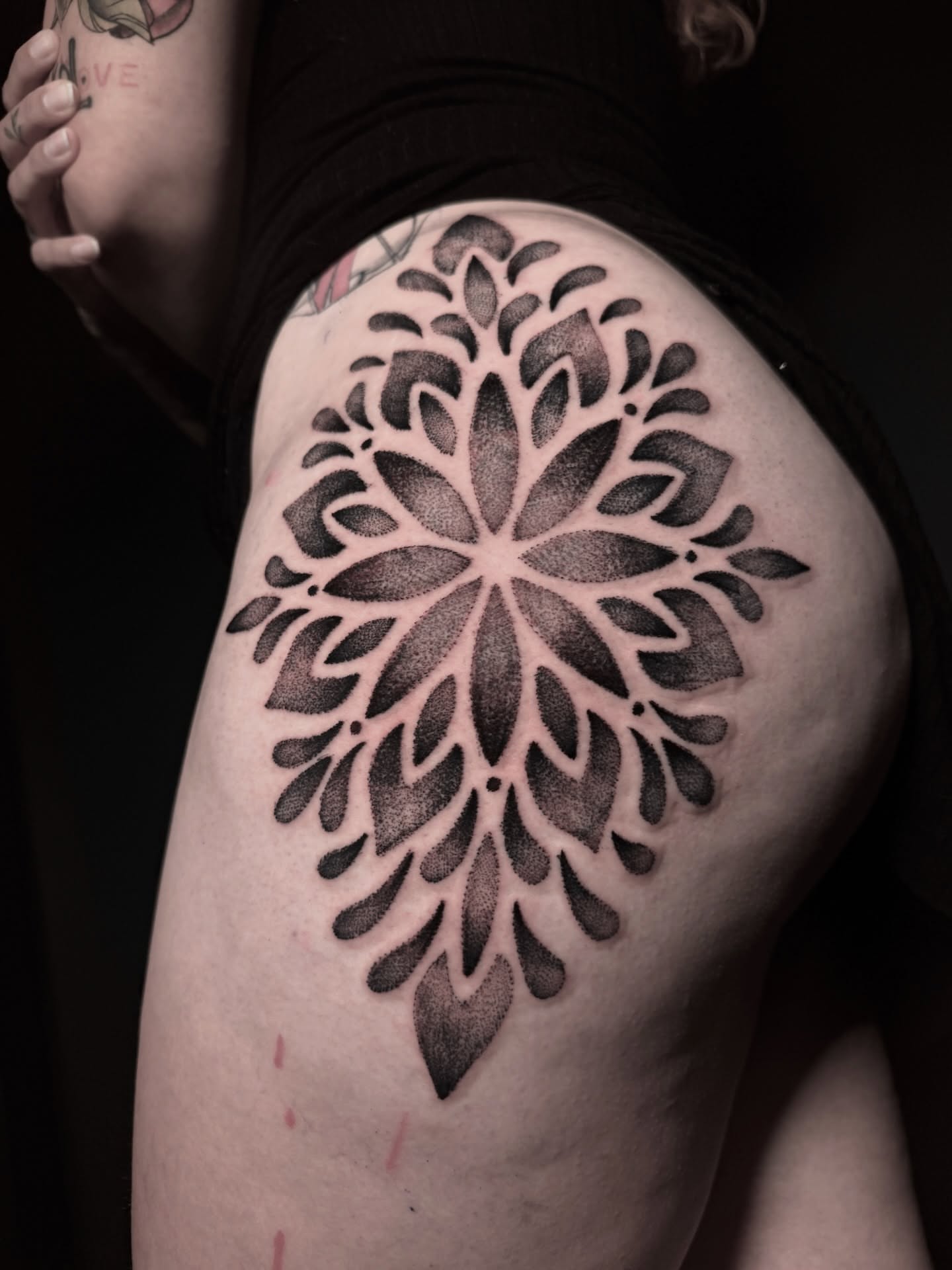 Lotus flower black and grey tattoo on the thigh by Alex Cantor