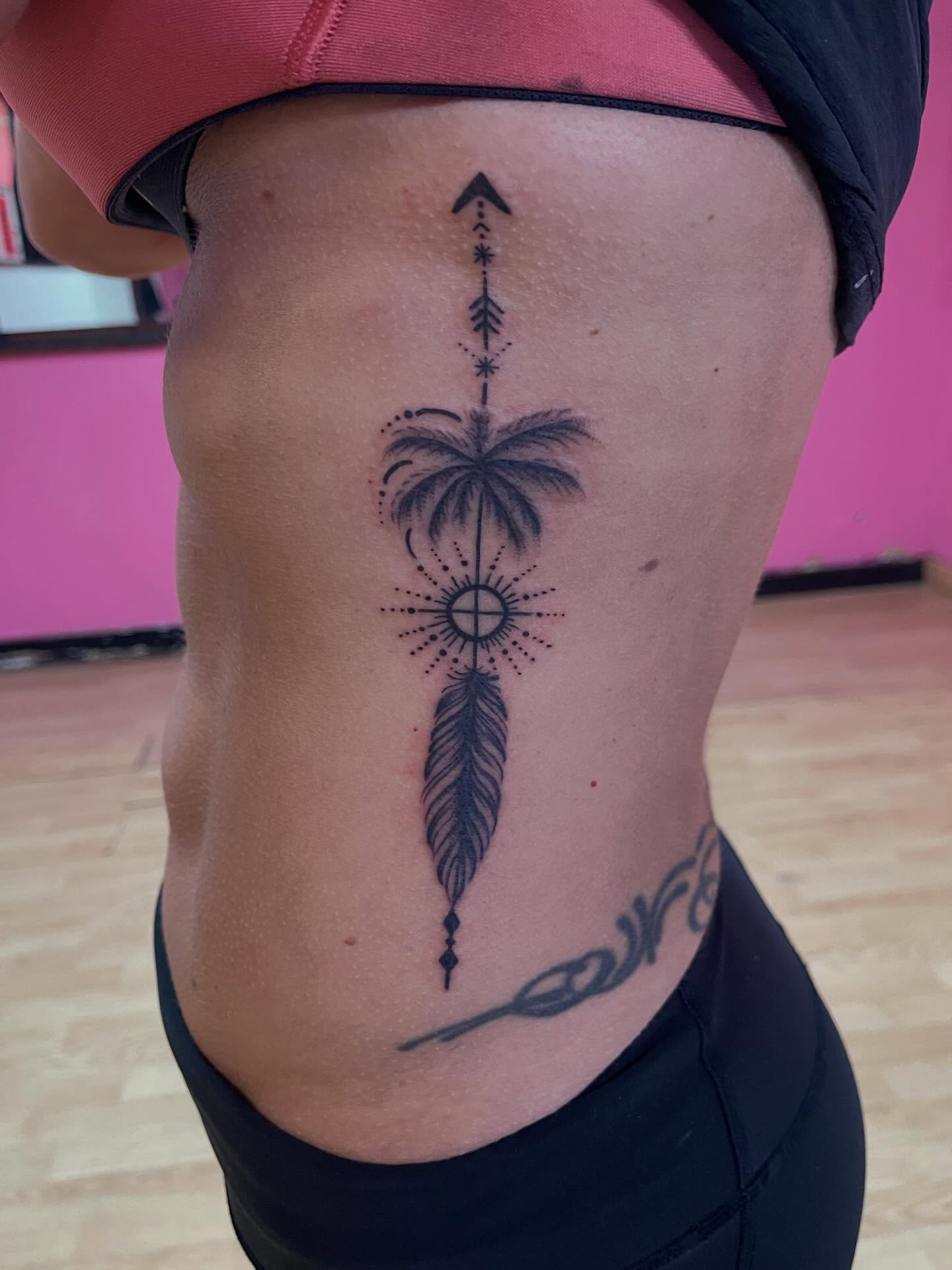 Palm tree and feather dotwork tattoo on the ribs by Yayo, New Britain, Connecticut