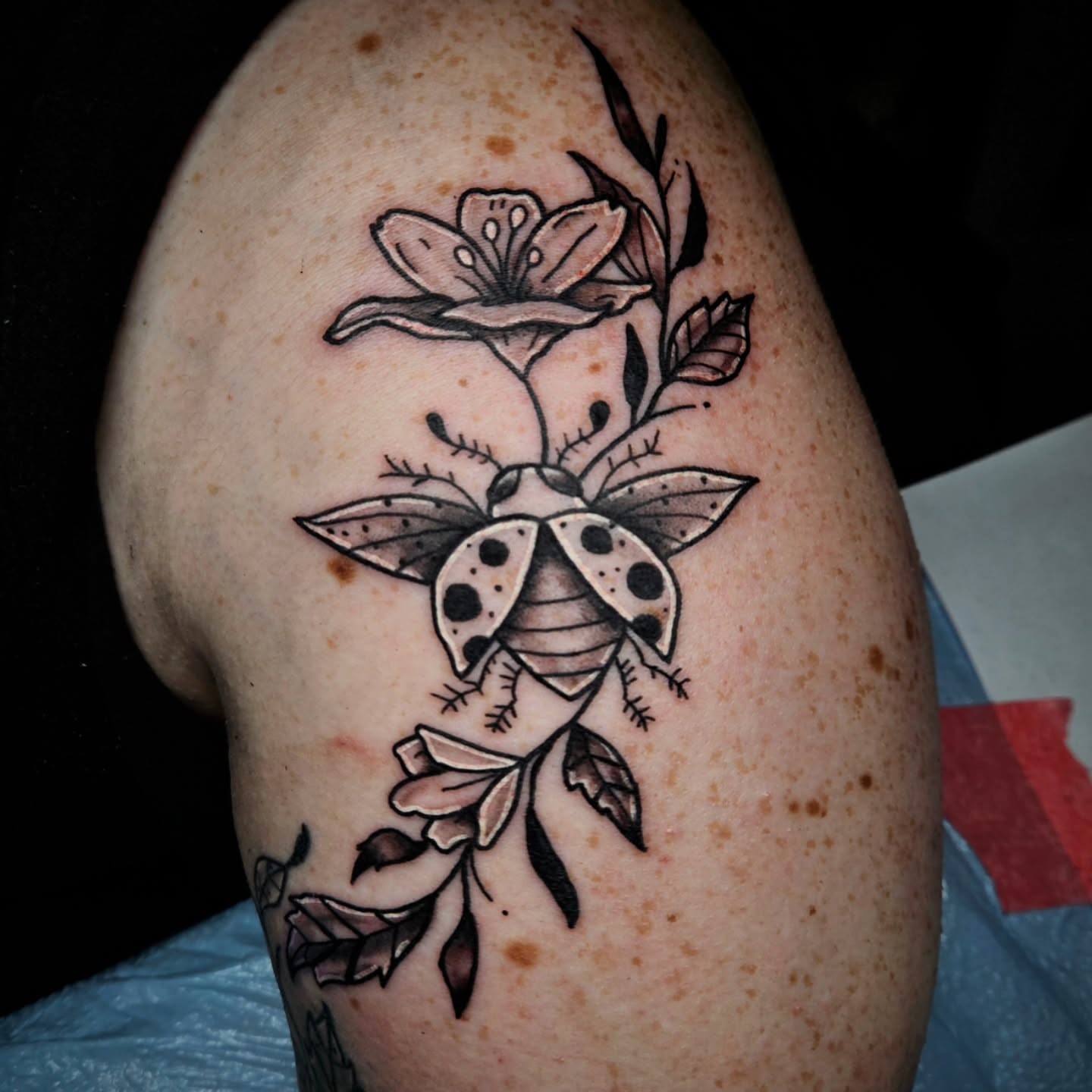 Ladybug and flower black and grey tattoo on the shoulder by 🌟Amanda 🌟