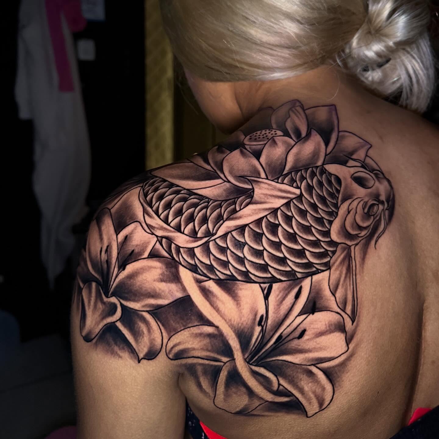 Koi fish and lotus realism tattoo on the shoulder by Chicago Tattoo Artist