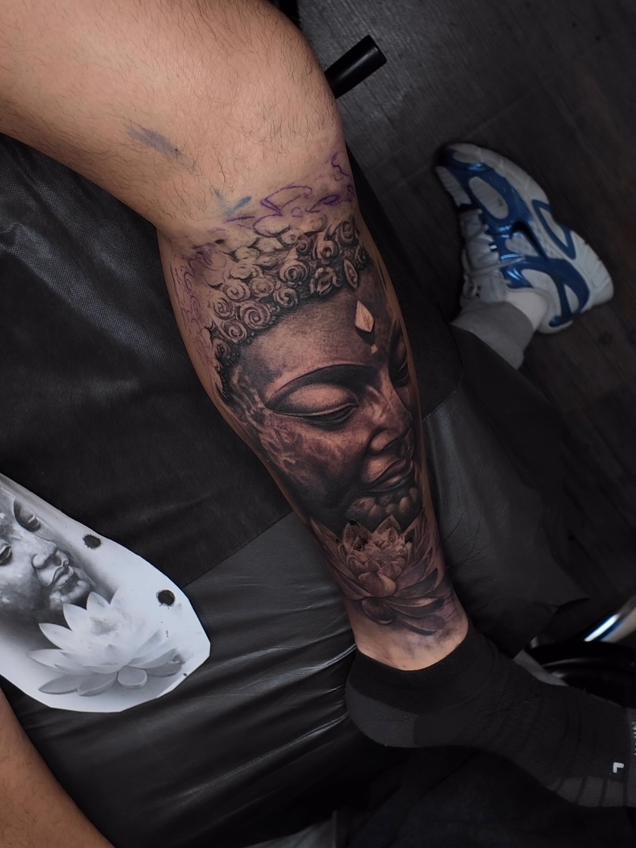 Buddha head realism tattoo on the forearm by Yudel