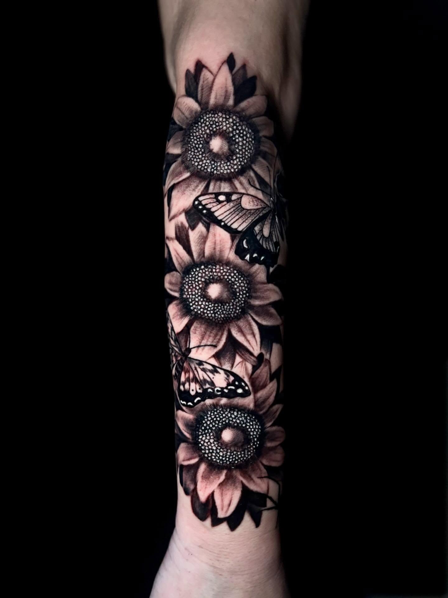 Sunflowers and butterflies dotwork tattoo on the forearm by Lee