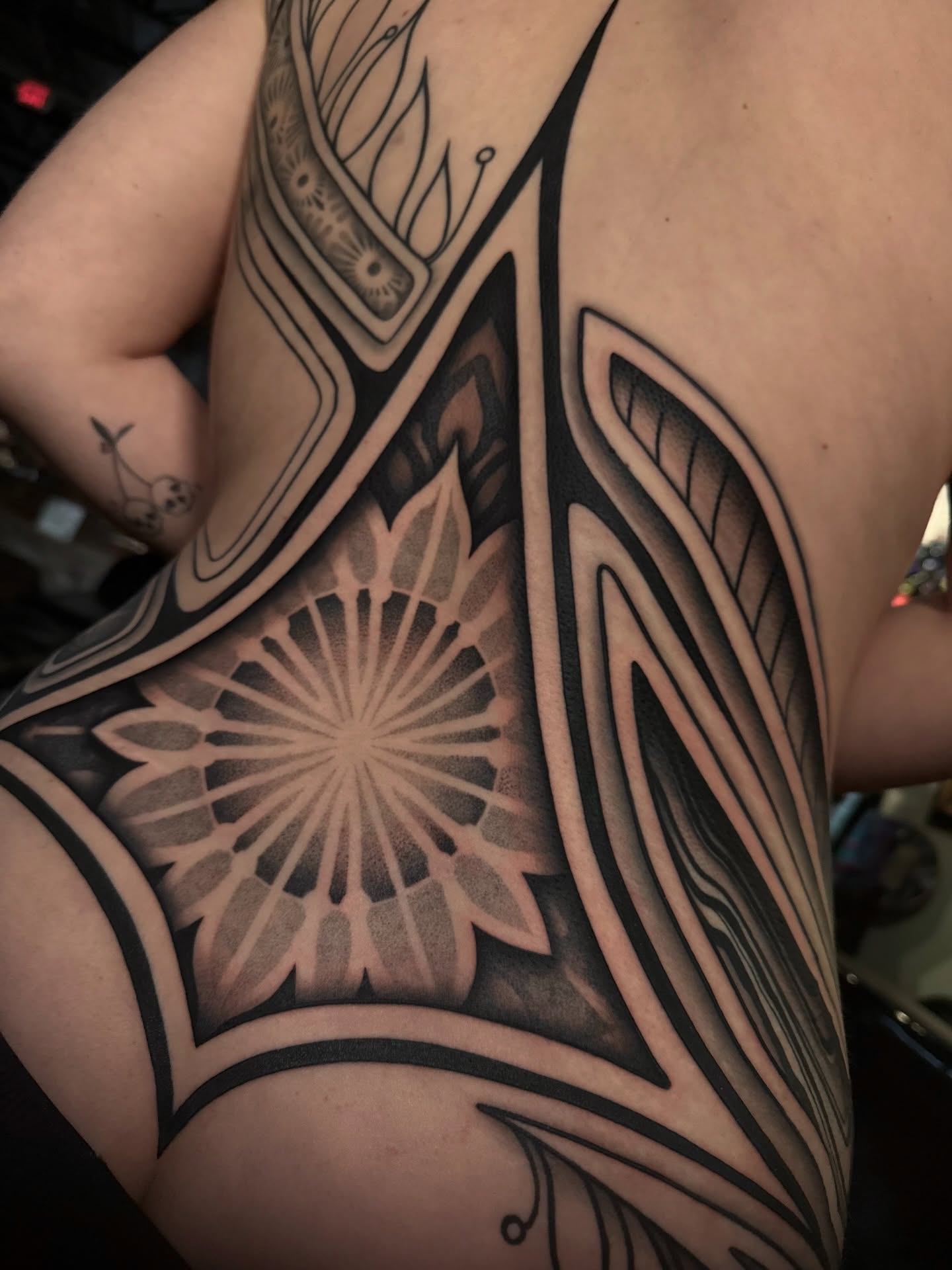 Geometric pattern geometric tattoo on the chest by Haley Corinne