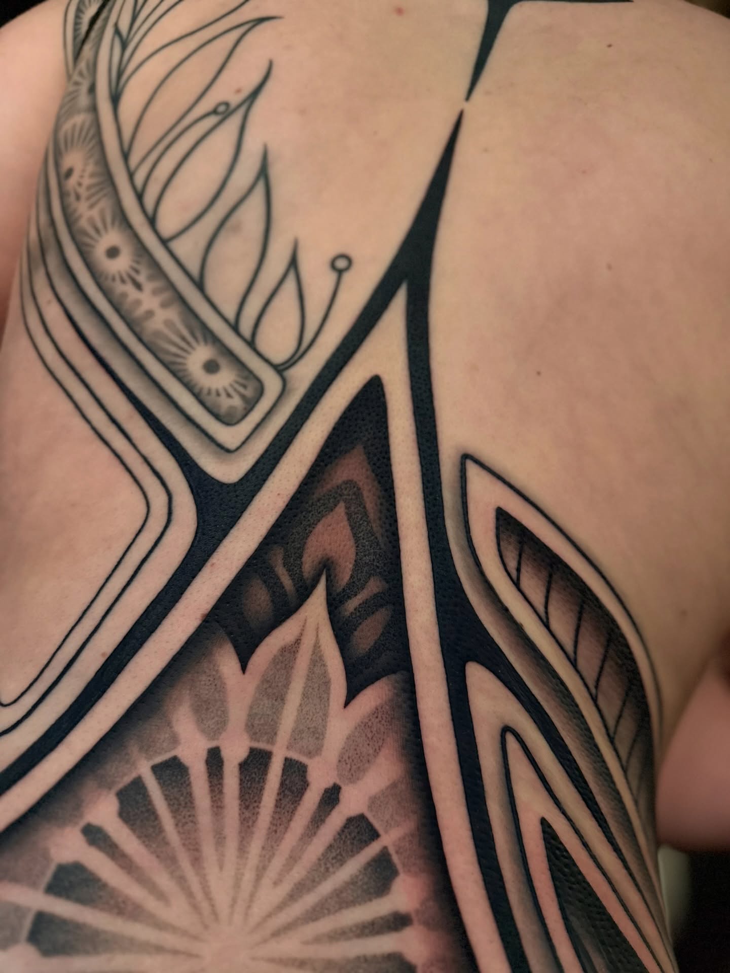 Geometric pattern geometric tattoo on the back by Haley Corinne