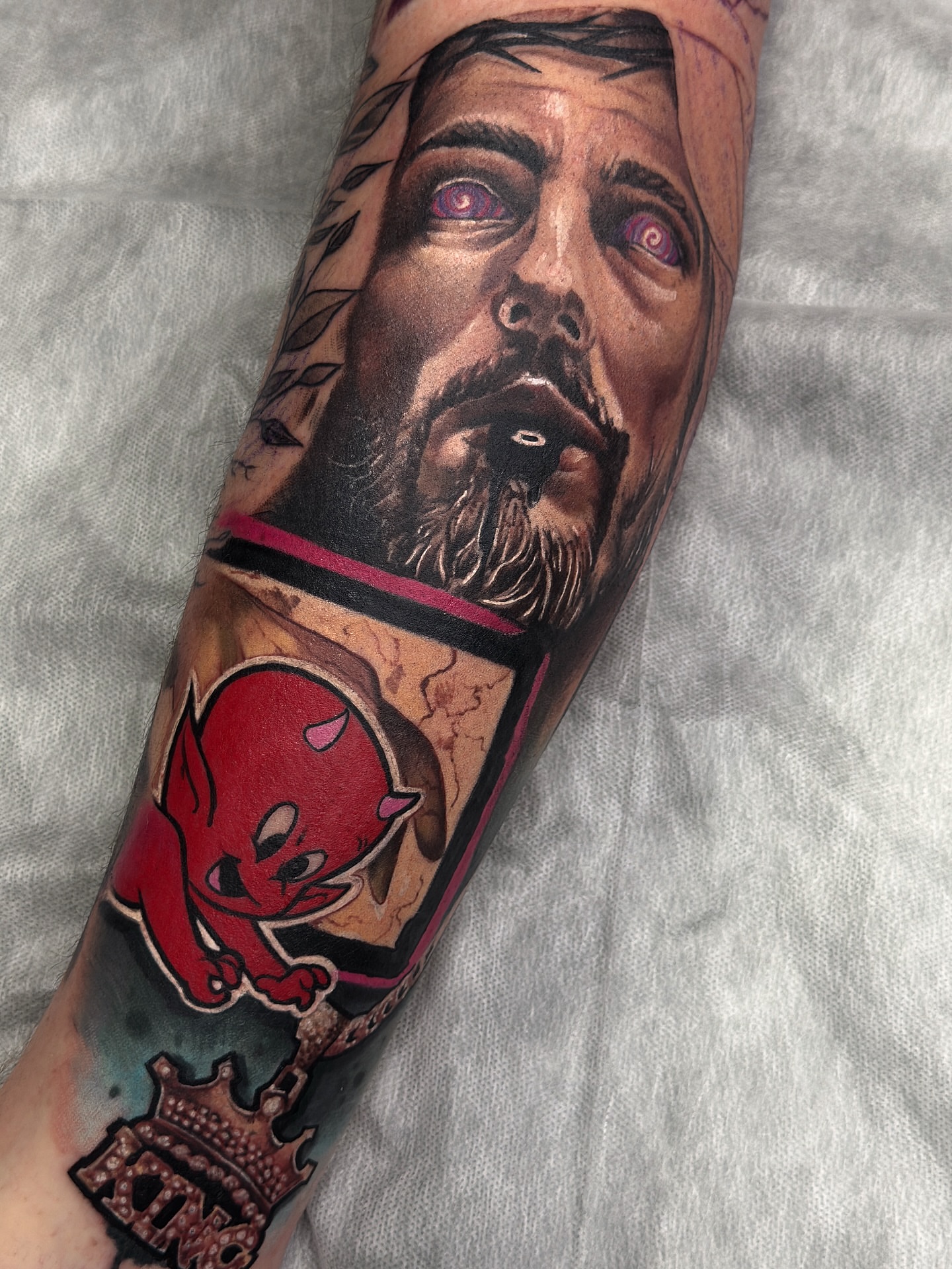 Man's face realism tattoo on the forearm by Donald Reynolds